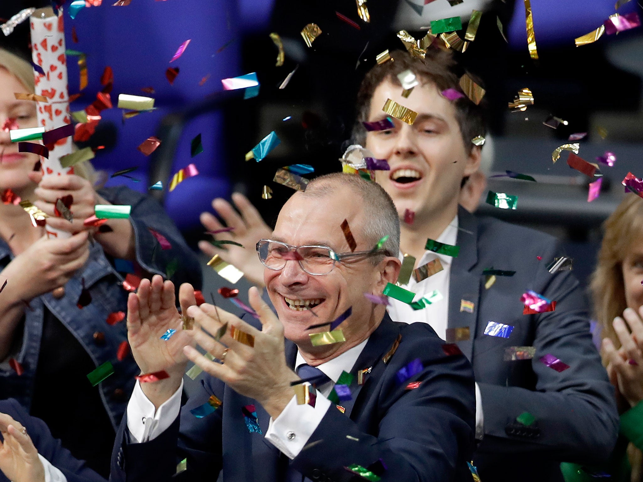 The Green Party's Volker Beck and members celebrate with confetti popper after the Bundestag voted to legalise same-sex marriage in Berlin on 30 June