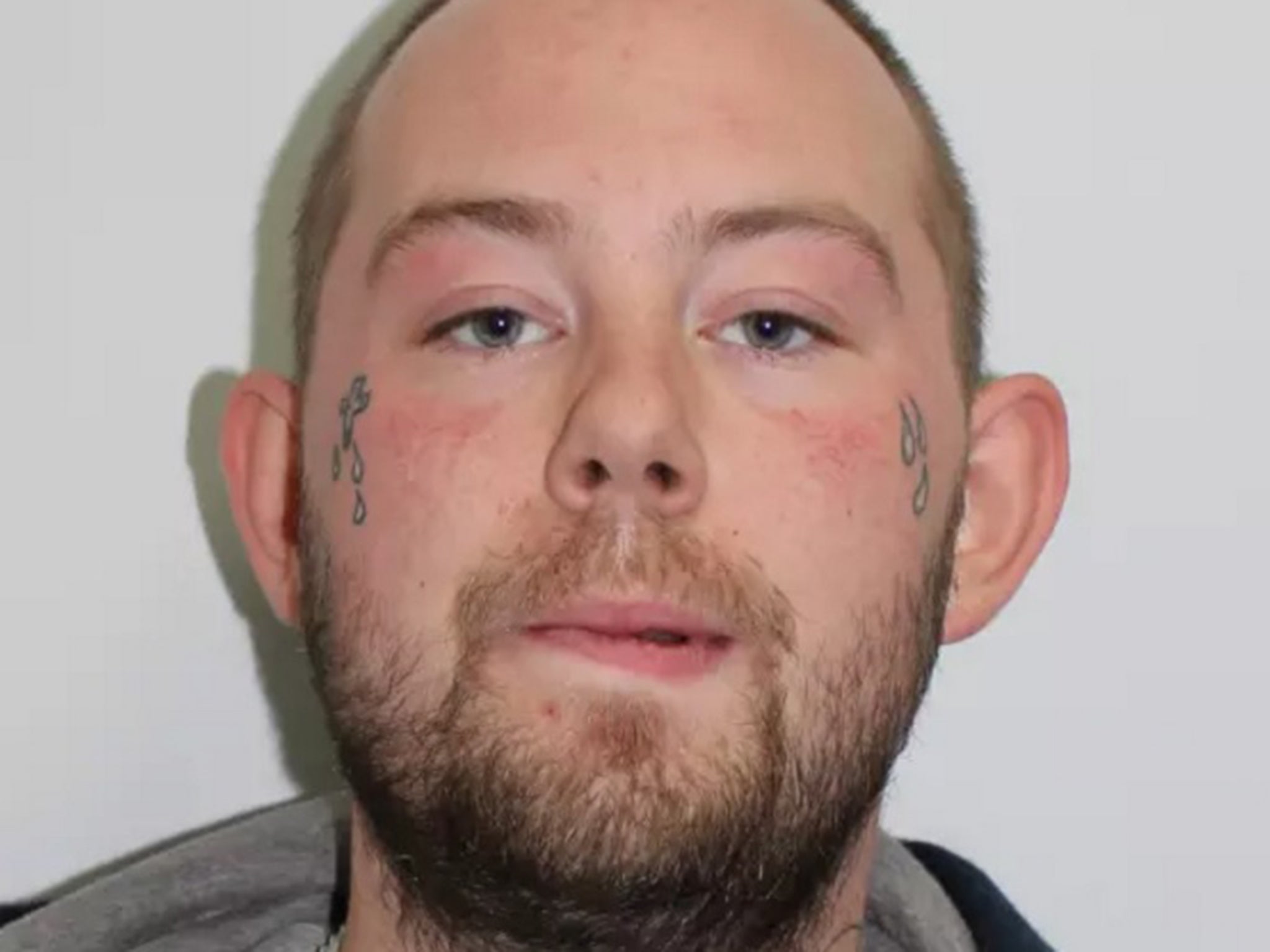 John Tomlin is wanted by Scotland Yard in connection with the acid attack