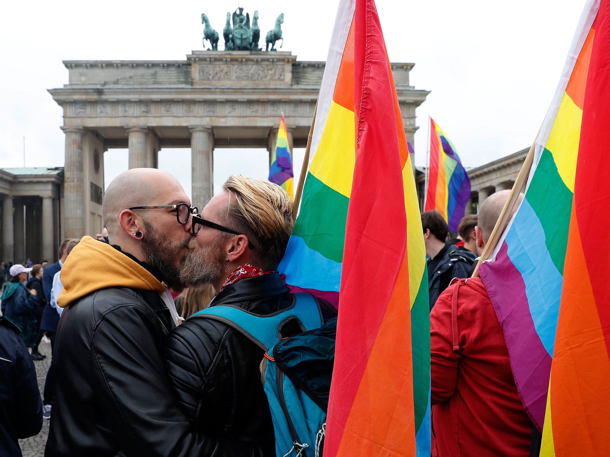 A couple kiss in front of the Brandenburg Gate as they celebrate the legalisation of same-sex marriage in Germany on 30 June