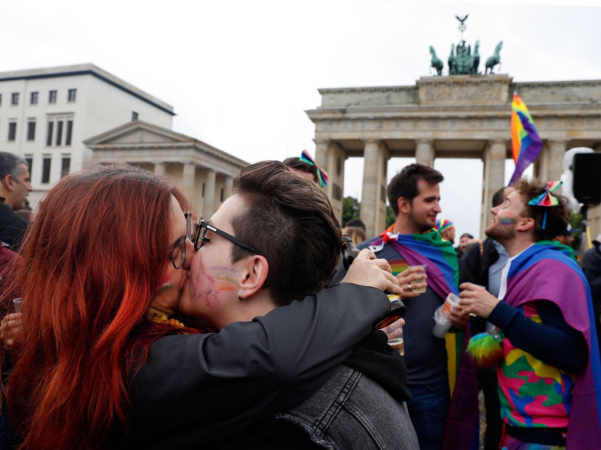 Gay couples gathered outside the Chancellery and Brandenburg Gate to kiss and hug, and wave rainbow flags