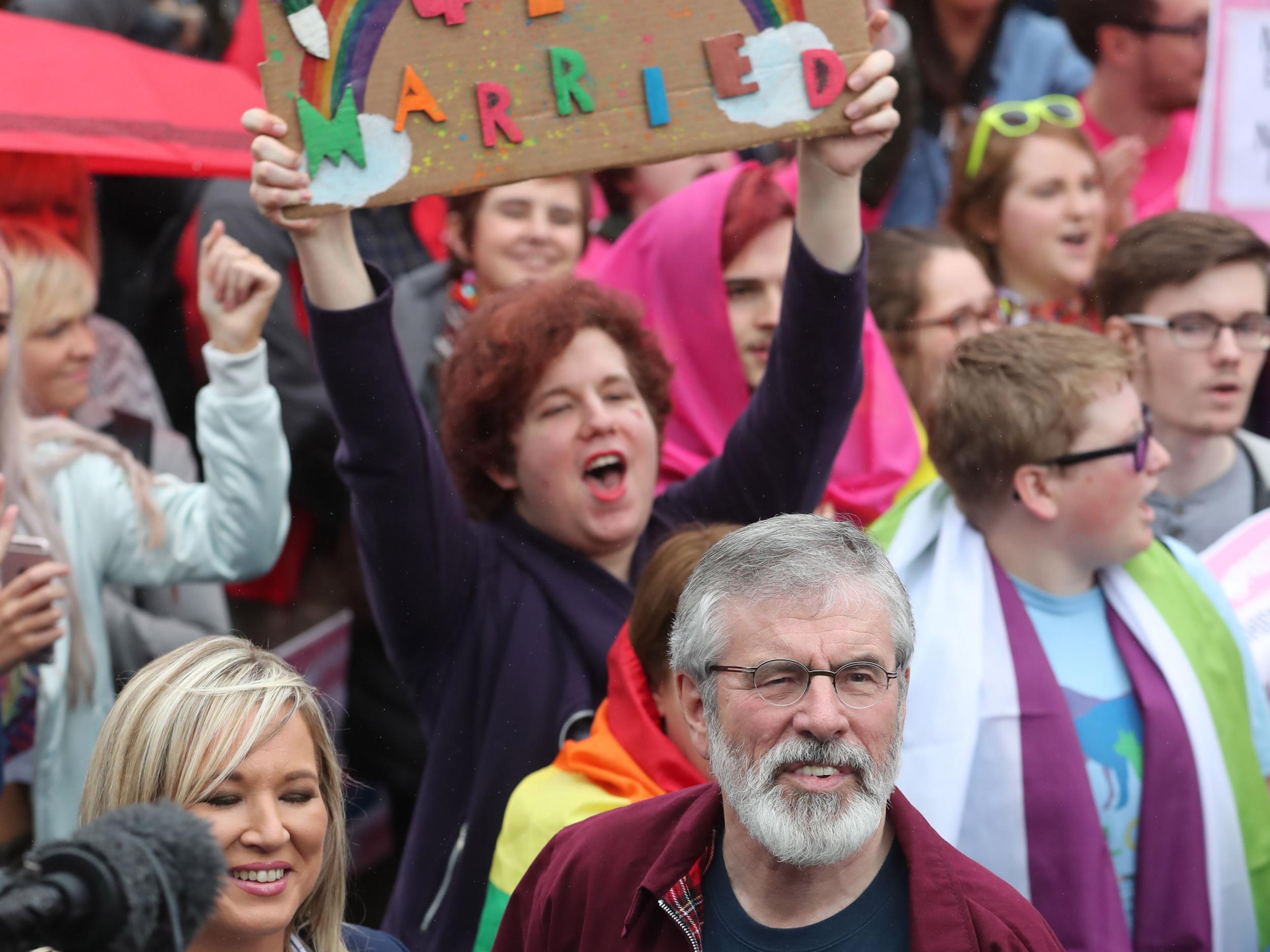 Sinn Fein's Northern Ireland leader Michelle O'Neill (L) and party president Gerry Adams (R) join campaigners