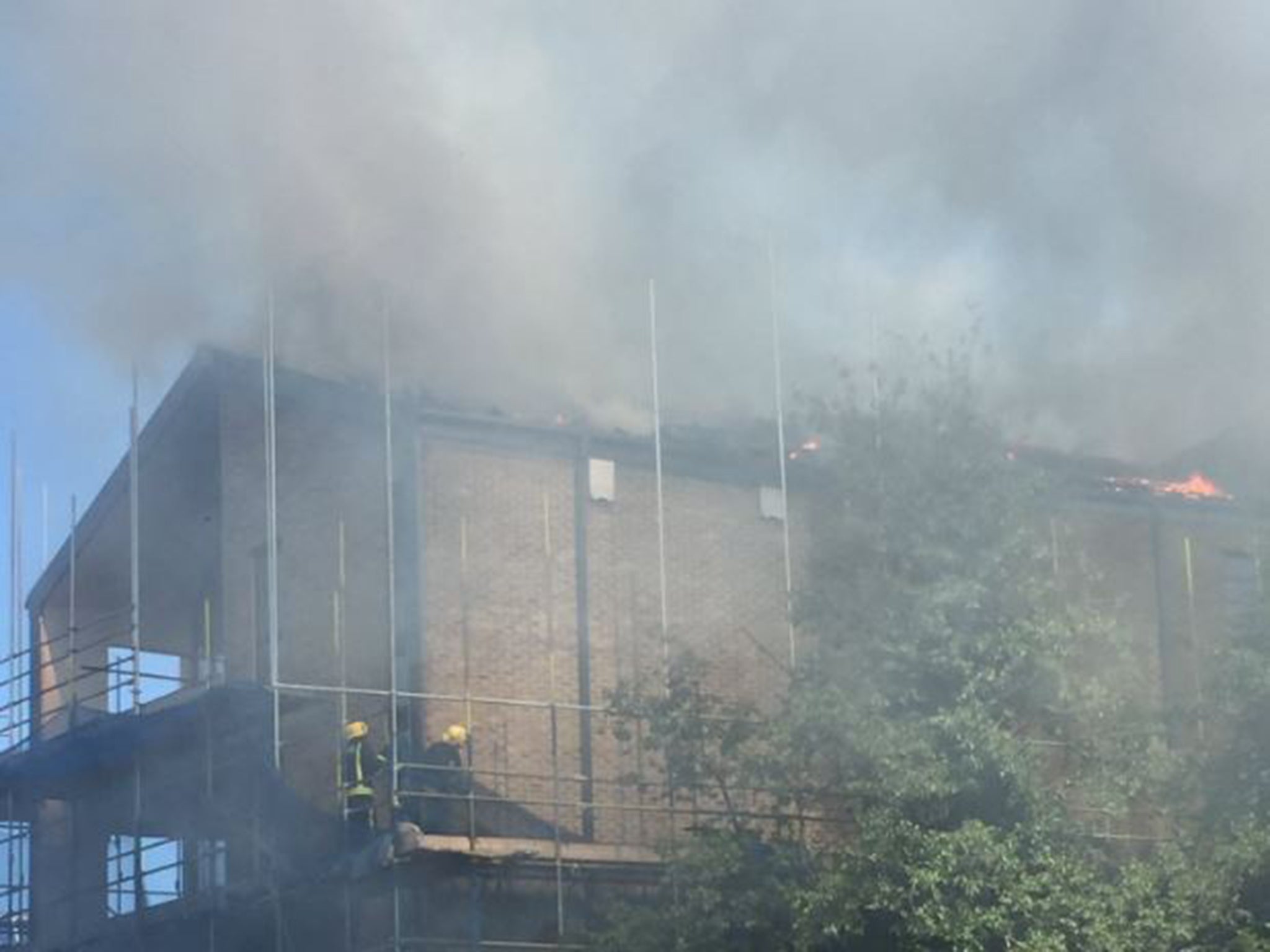 Firefighters continue to tackle the blaze in Mace Street, Bethnal Green, east London