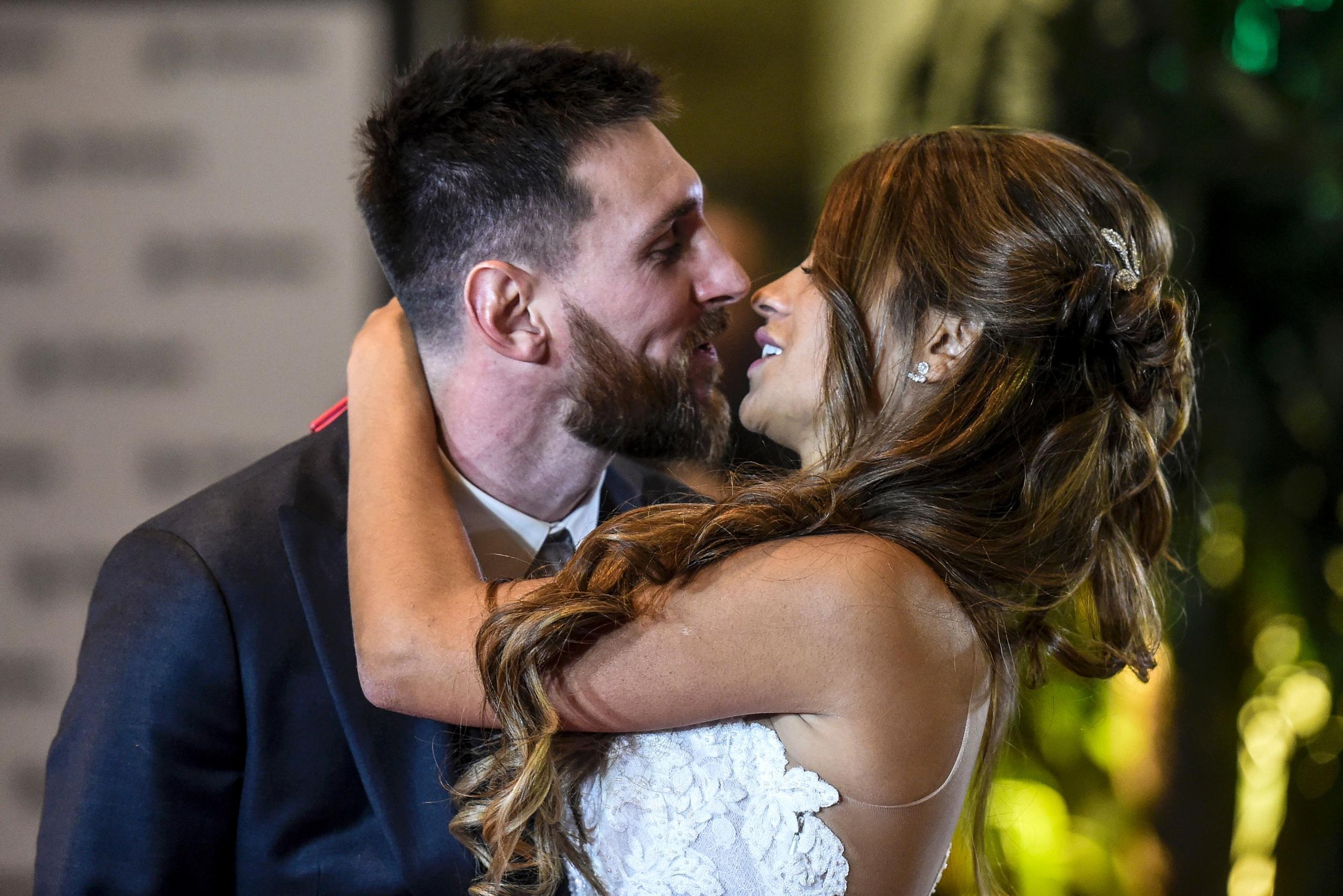 Lionel Messi moves to plant a kiss on his new bride - but it is claimed that there was some tension on the day