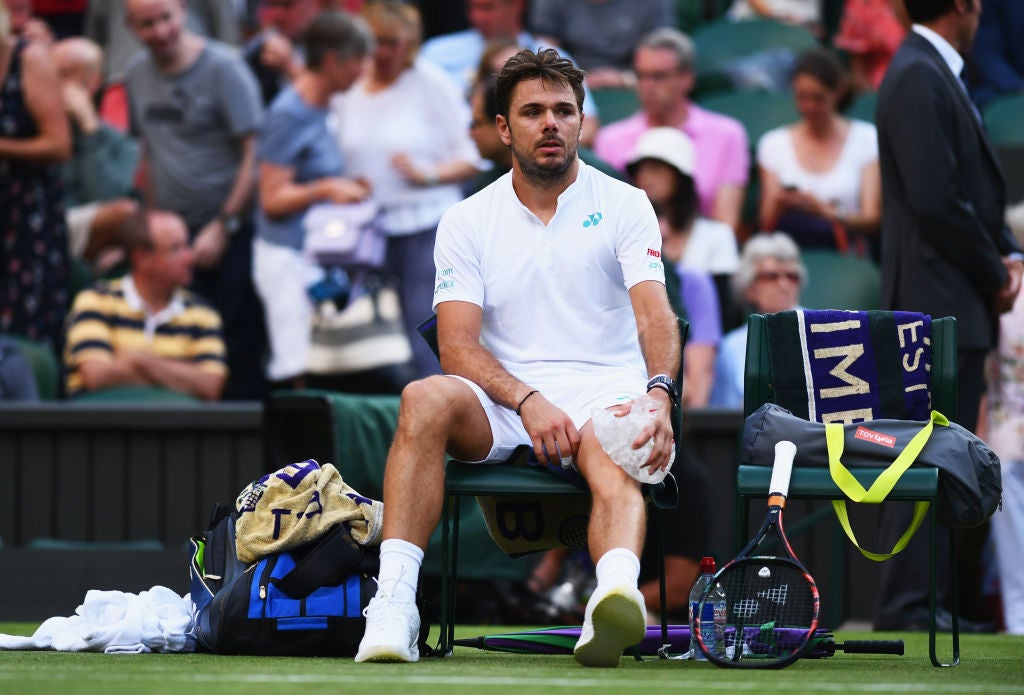 Stan Wawrinka of Switzerland puts ice on his knee during this year’s Wimbledon (Getty)