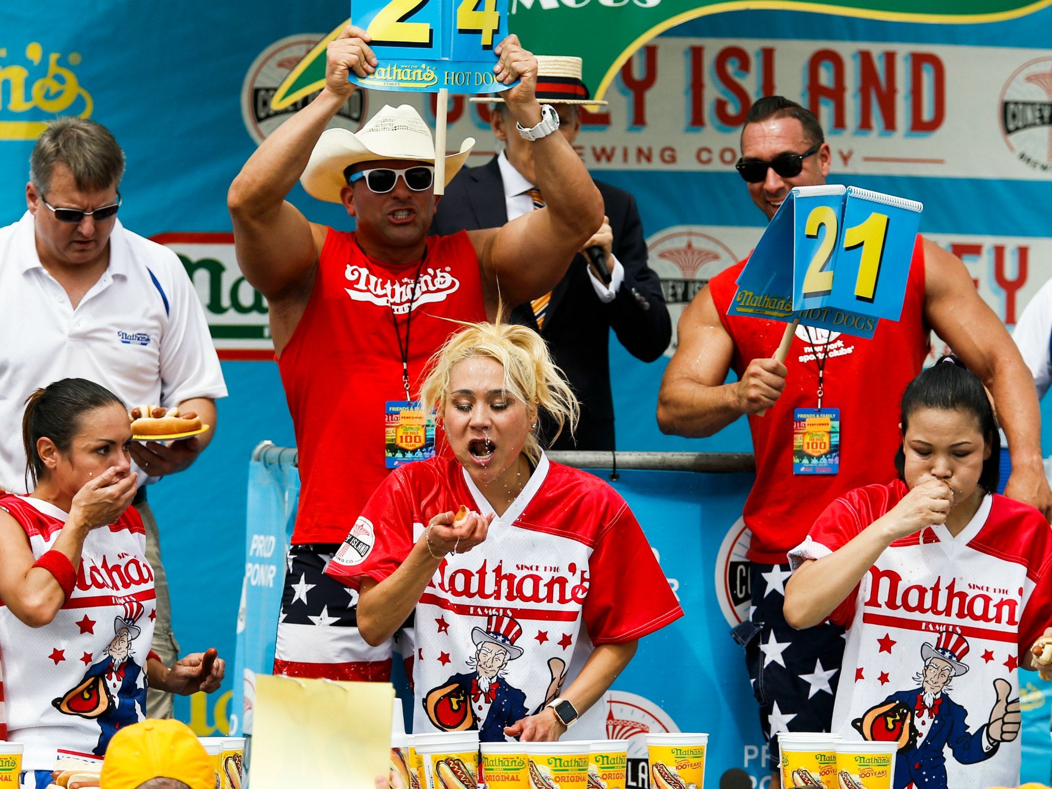 Michelle Lesco, left, Miki Sudo, centre, and Sonya Thomas compete in the Nathan's Famous Hotdog eating contest