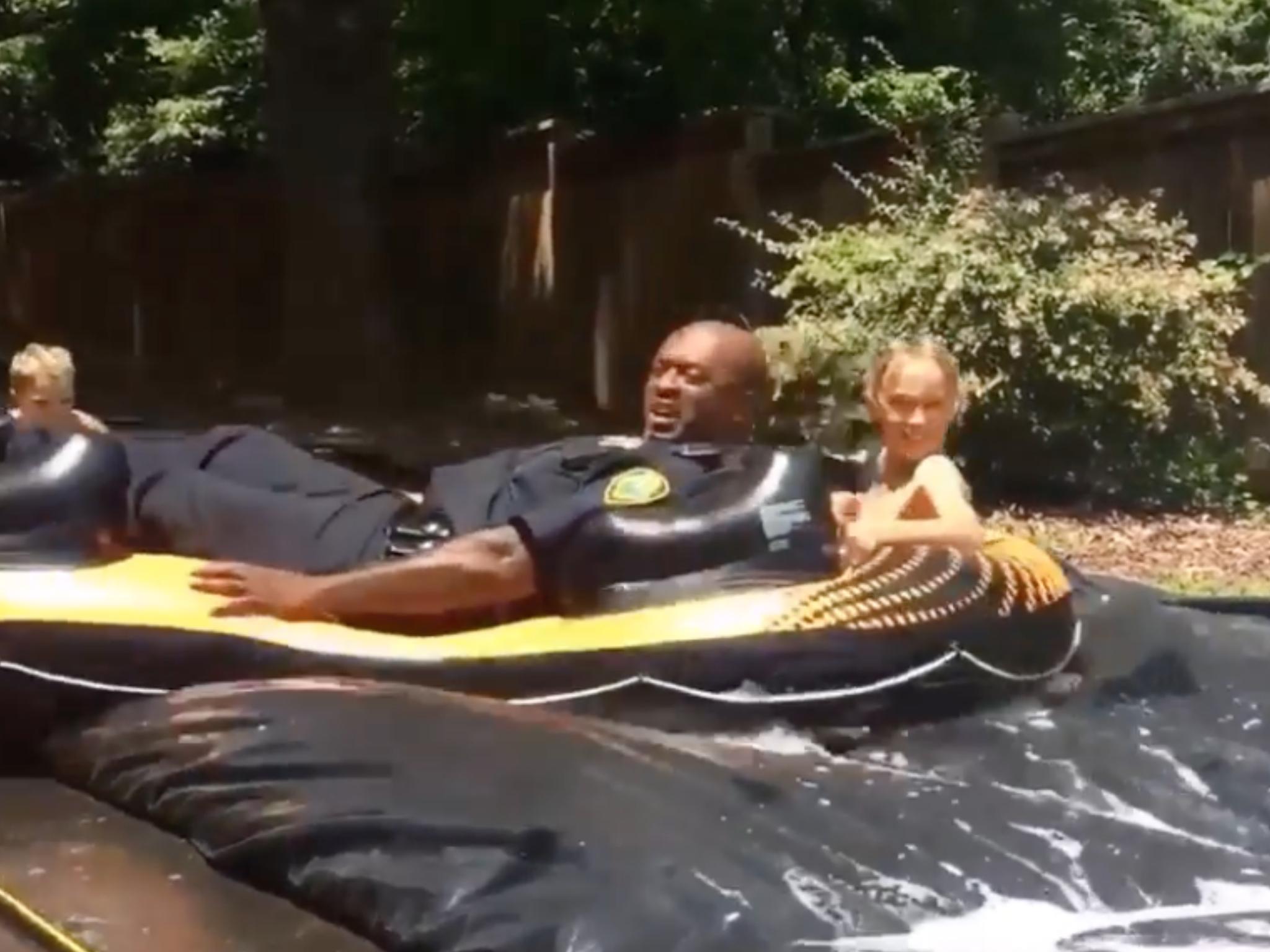 Asheville, North Carolina police officer Joe Jones takes his turn at a block party slip n' slide (Katlen Joyce Smith/Facebook)