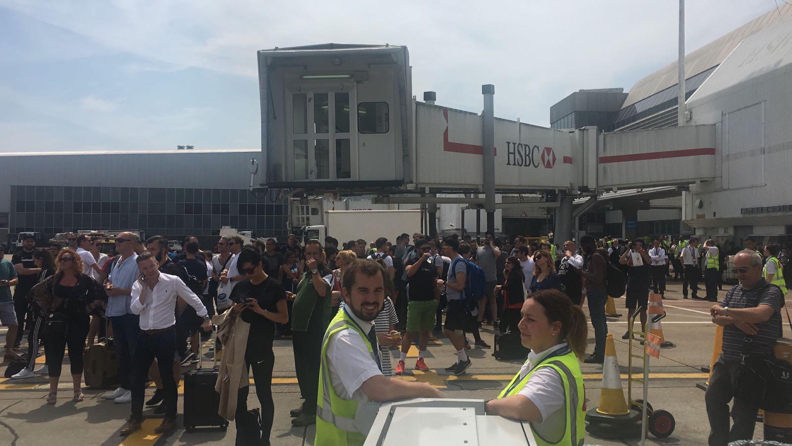 Passengers on the runway after being evacuated