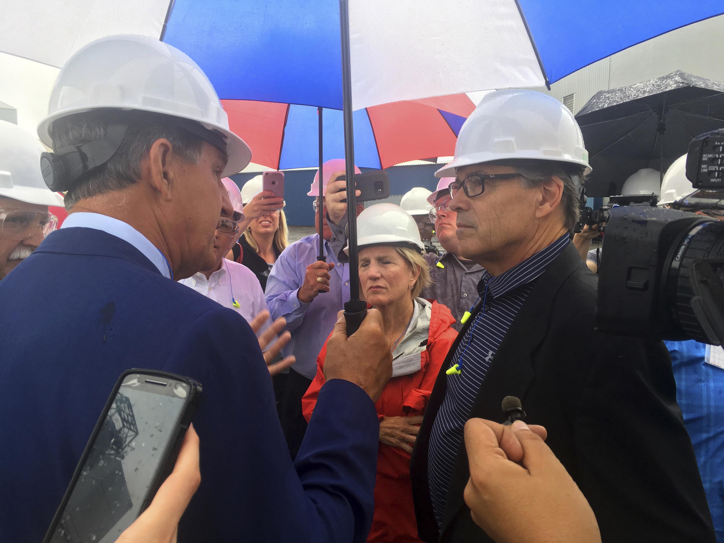 Energy Secretary Rick Perry, right, talks with Democratic Senator Joe Manchin and Republican Senator Shelley Moore Capito outside the coal-burning Longview Power Plant in Maidsville, West Virginia