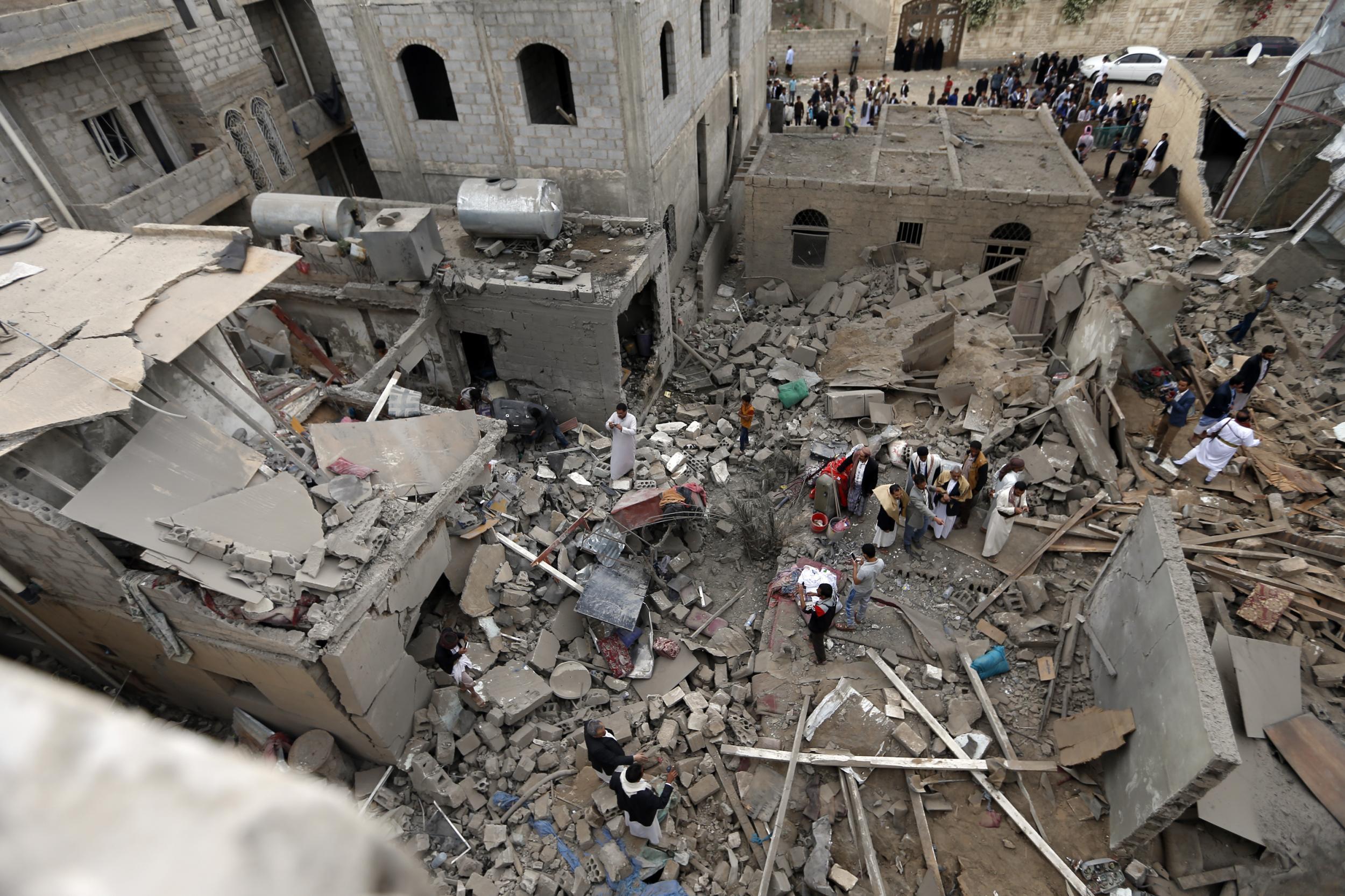 Yemenis stand on the rubble of houses destroyed in a suspected Saudi-led coalition air strike in Sanaa on June 9, 2017. Four civilians, including two teenagers, died 'in a strike by the coalition that targeted a civilian house behind the presidential palace in the south of the capital', a medical source said