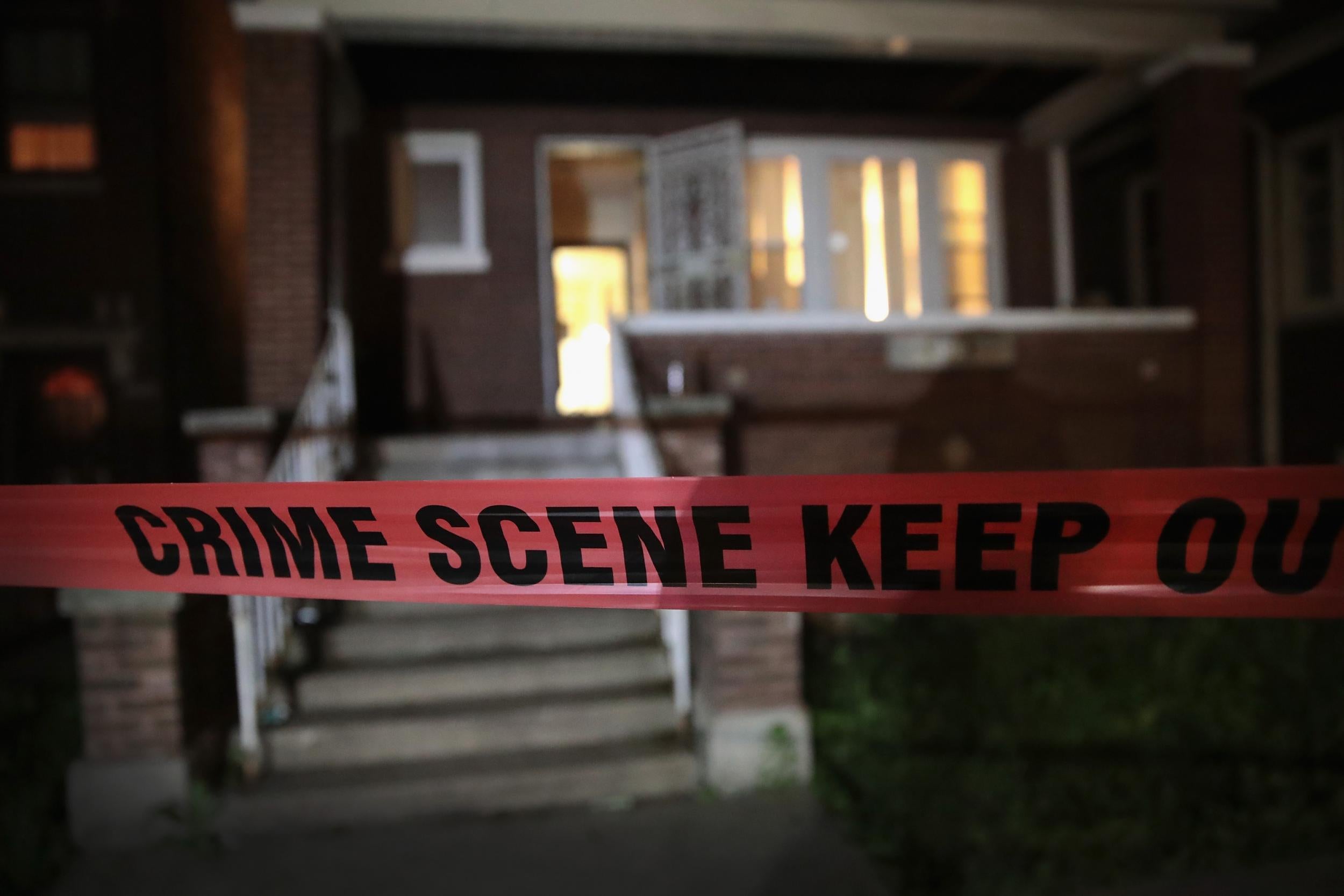 Police tape is shown around a house. Authorities are still investigating a shooting in Colerain Township, Ohio that injured eight