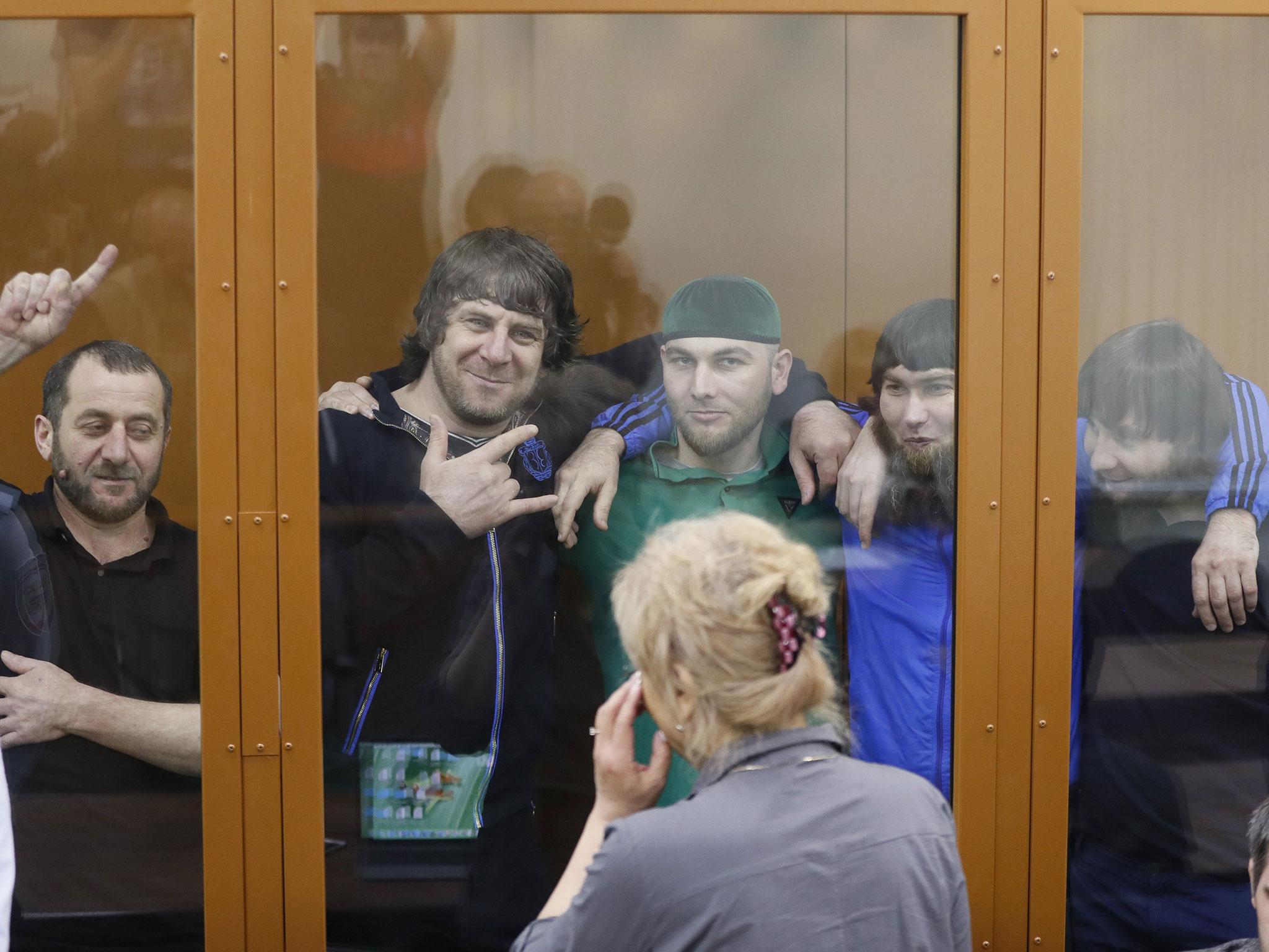 Convicts in the Nemtsov murder case smile while hearing the prosecutor's plea at the Moscow district military court, 12 July, 2017.