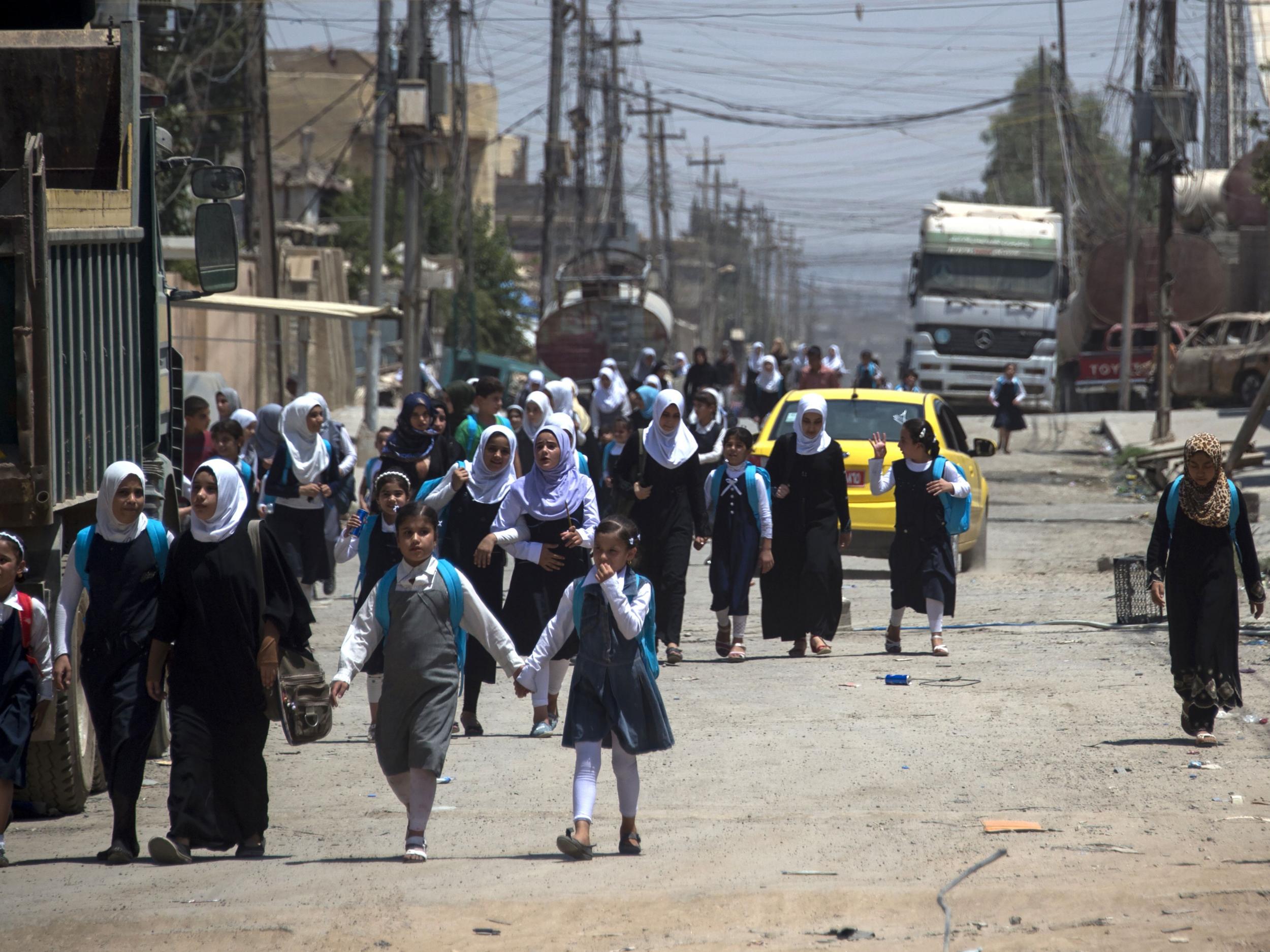 Iraqi girls walk back from school in west Mosul after the government declared it had driven the Islamic State from its one-time stronghold