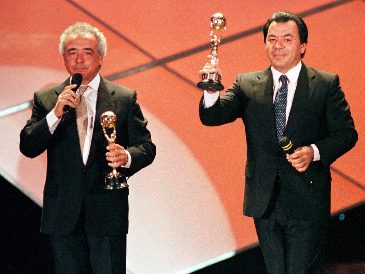 Los Del Rio members Rafael Ruiz, left, and Antonio Romero Monge wave their music awards at the 1997 World Music Awards.