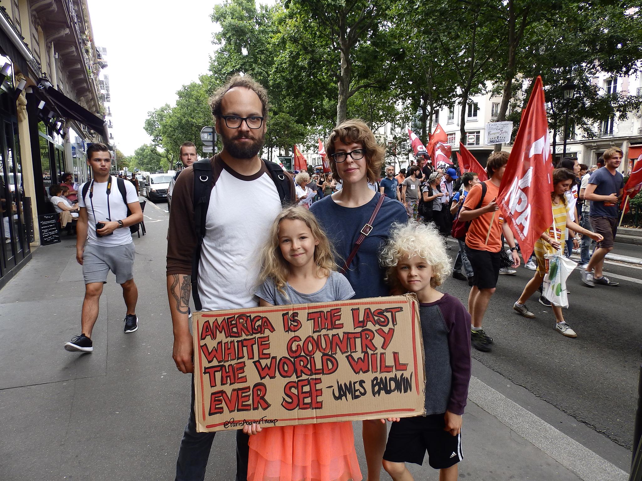 &#13;
American family Benjamin Paloff, Meg Thomas and their children Breina, nine, and Zeke, seven, at the Bastille Day march in Paris &#13;