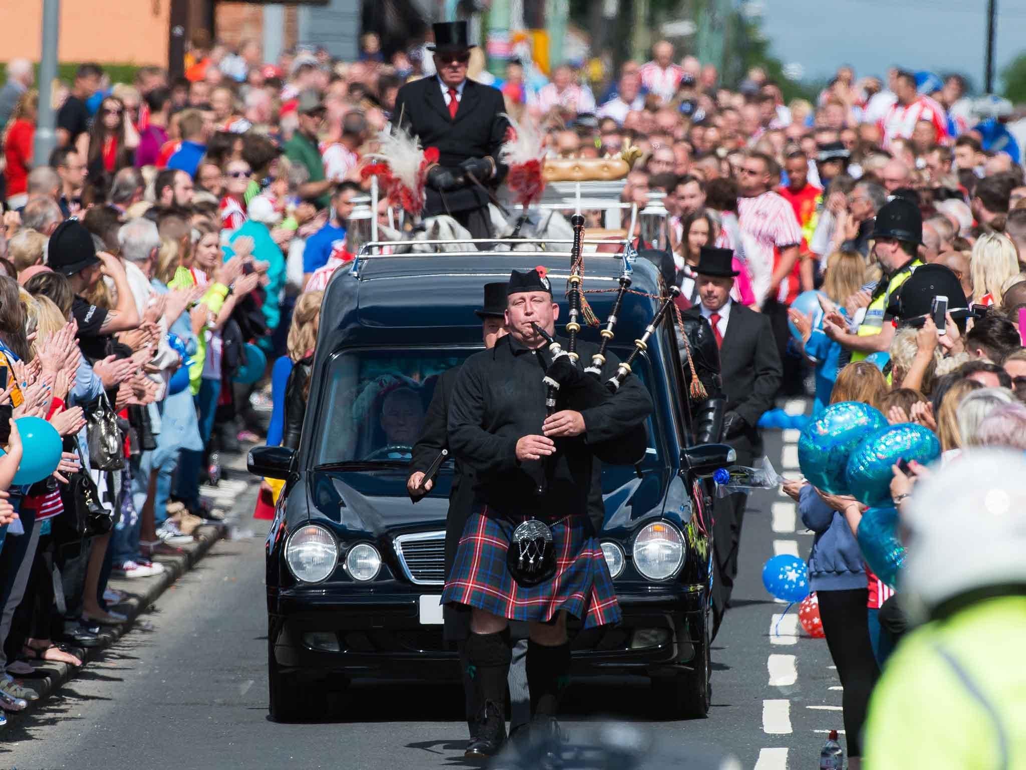 Thousands of fans lined the streets for the funeral procession of Bradley