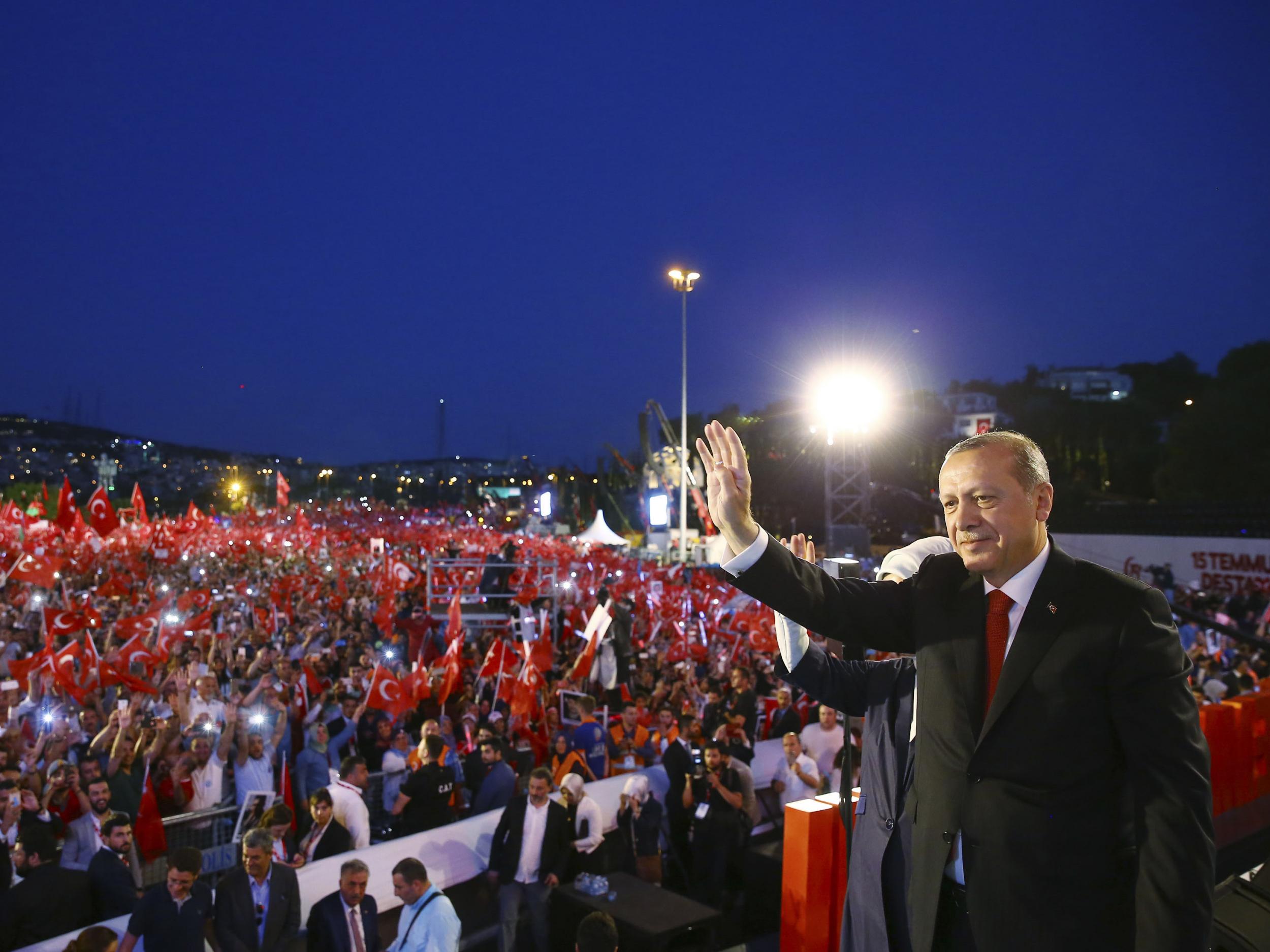 President Erodgan acknowledges supporters at a rally celebrating the anniversary of the failed coup – which he has used to justify sweeping attacks on democracy and human rights