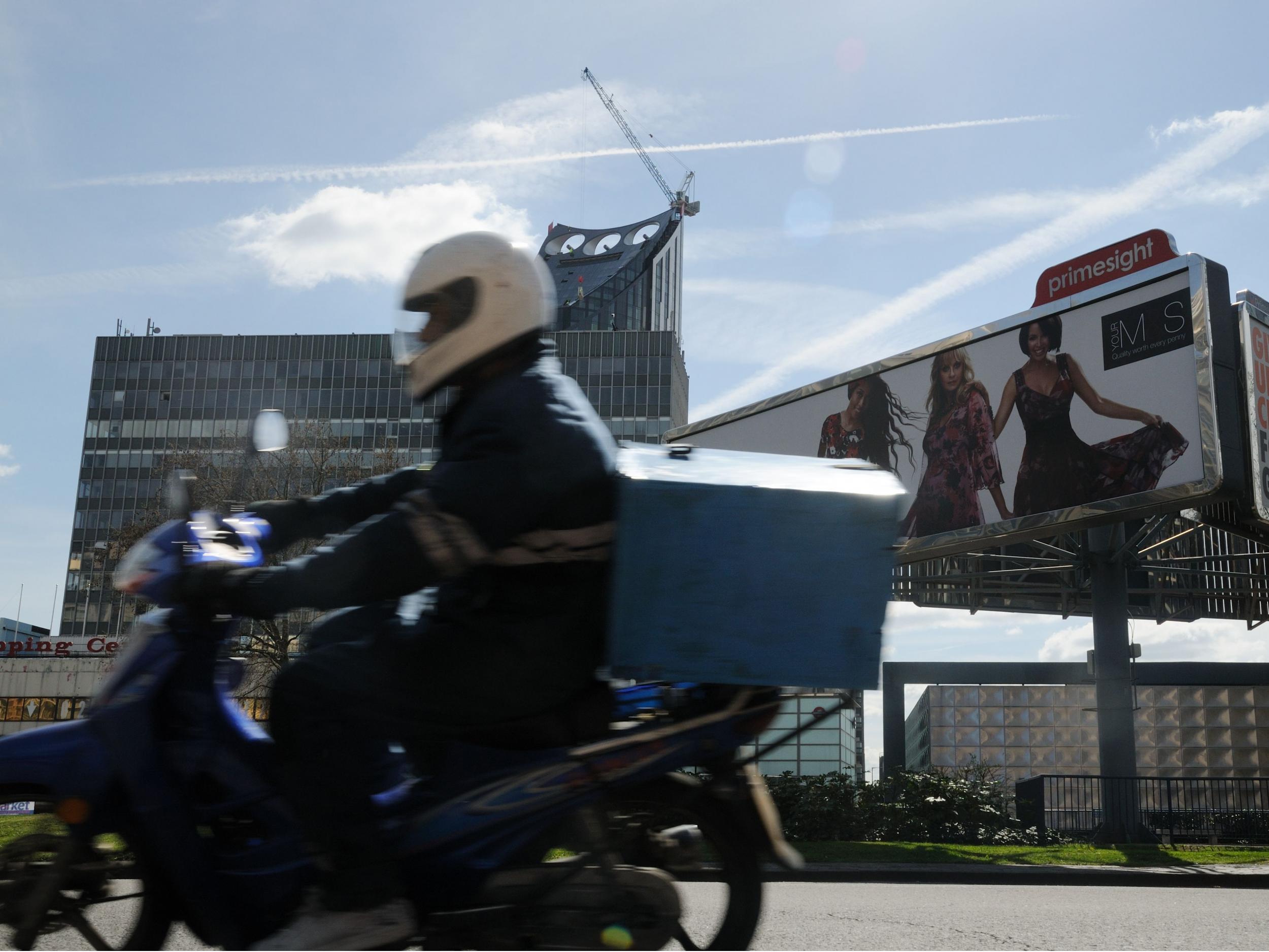 A moped delivery rider at Elephant and Castle in London. The riders have been targeted for their vehicles