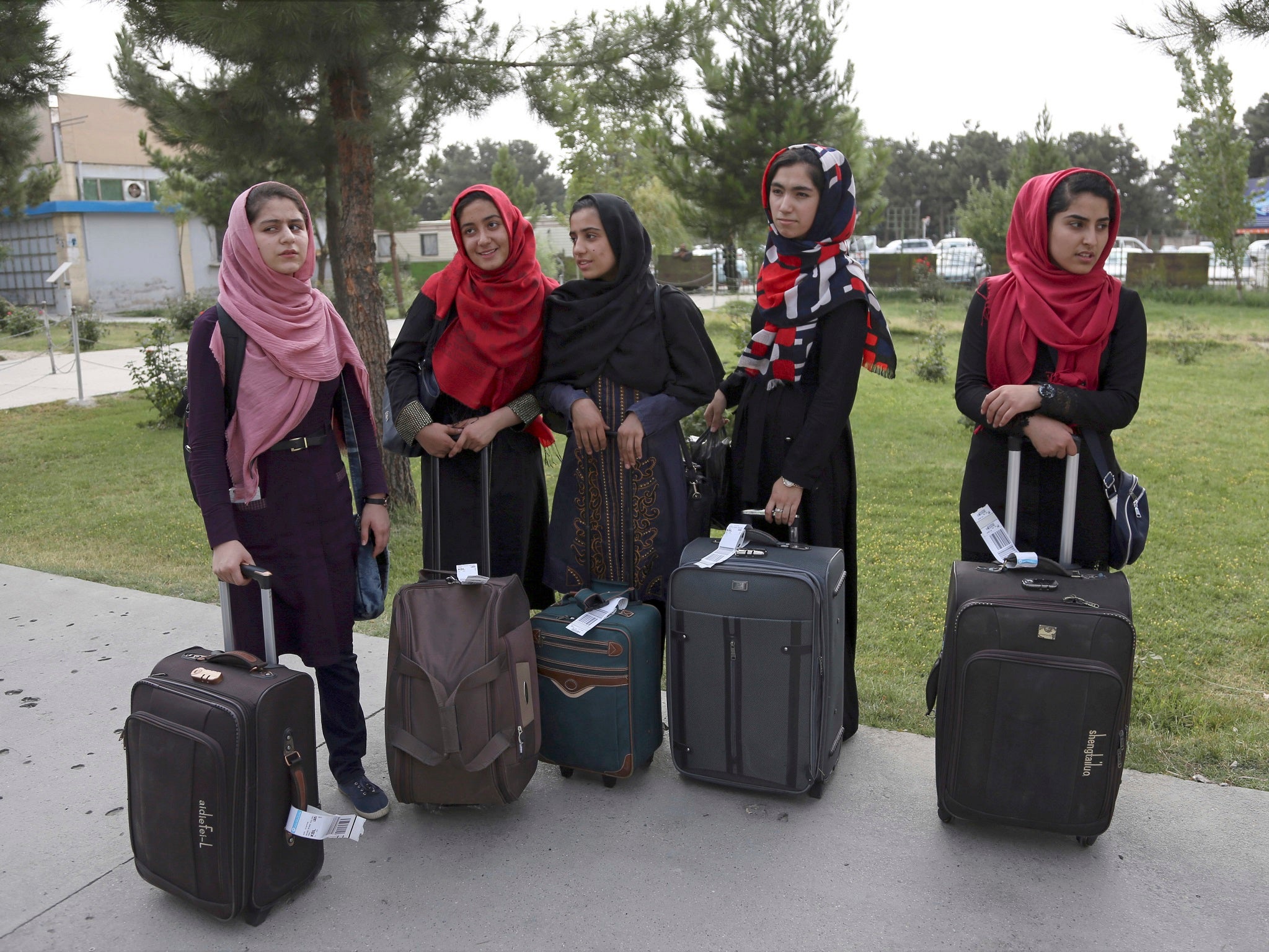 Members of the female robotics team arrive from Herat province to receive visas from the US embassy, at the Hamid Karzai International Airport, in Kabul, Afghanistan