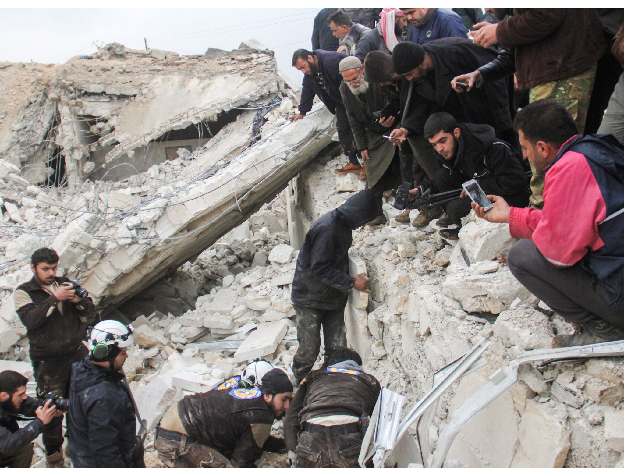 White Helmets digging through the rubble of a mosque in Aleppo province following a US airstrike