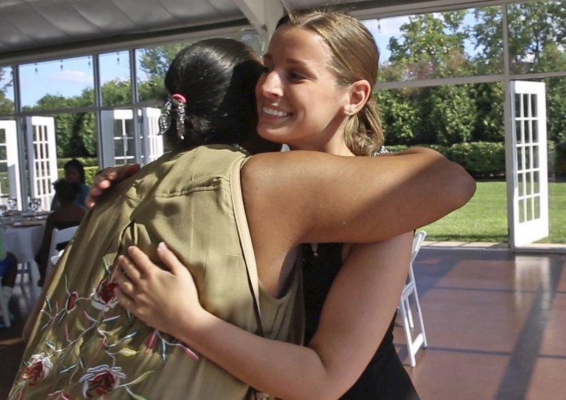 Guest Janice Williamson-Cox hugs Sarah Cummins as she arrives at the Ritz Charles