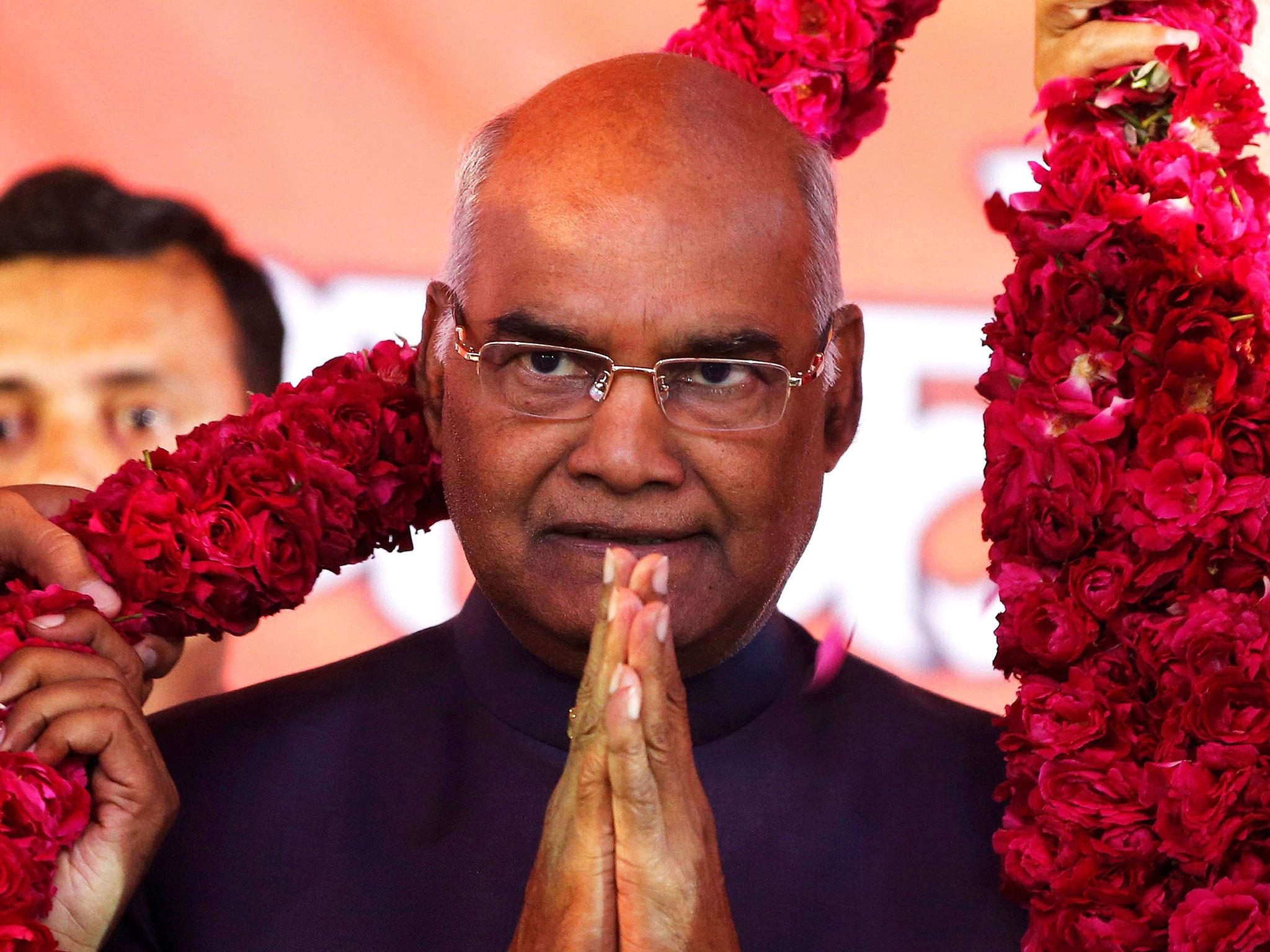 Supporters of Ram Nath Kovind, present him with a garland during a welcoming ceremony as part of his nation-wide tour, in Ahmedabad, India