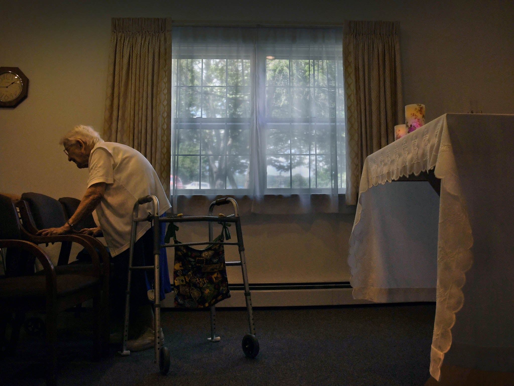 &#13;
Sister Mary John Goles prepares to leave the chapel after a prayer service at the house where several nuns live&#13;