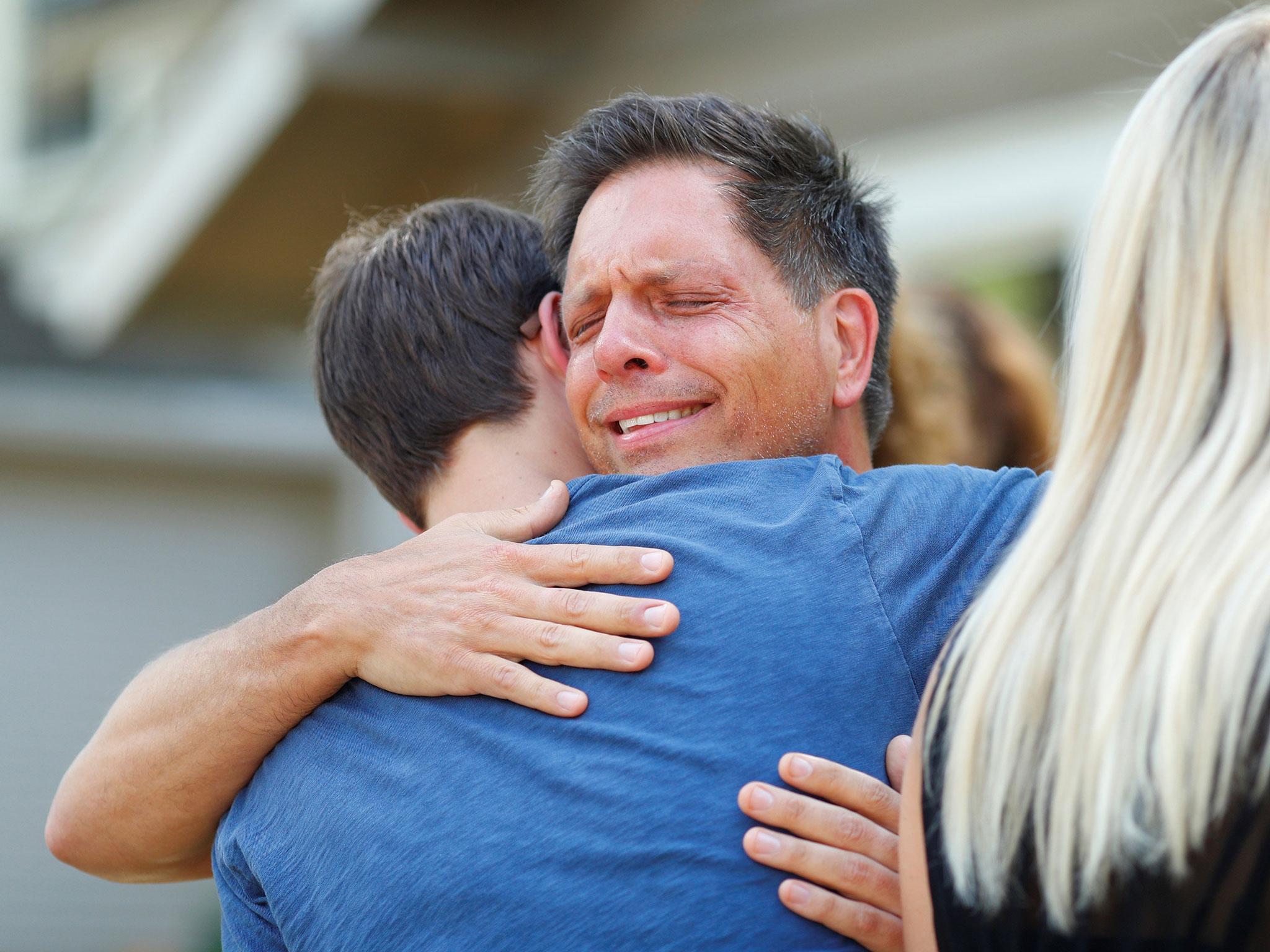 &#13;
Don Damond hugs a neighbour after reading a statement about his fiance &#13;