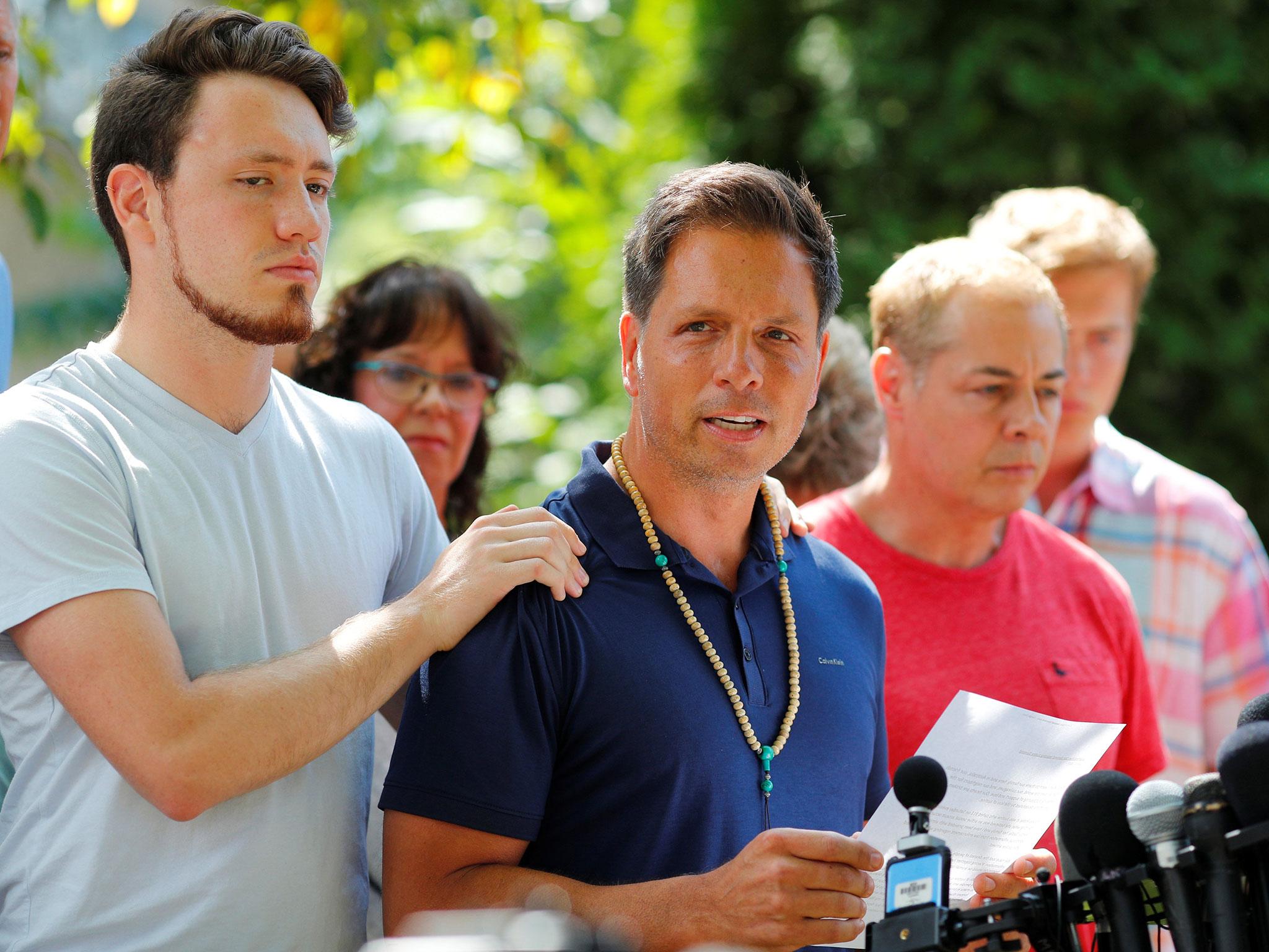 Don Damond is comforted by his son Zach Damond as he speaks to the media about his fiance Justine Damond