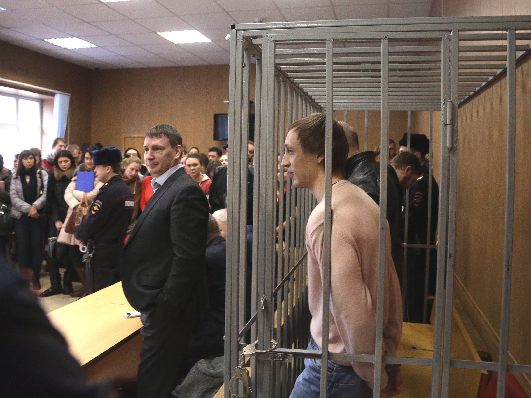 &#13;
Pavel Dmitrichenko, a dancer at Russia's Bolshoi Ballet, stands inside the defendant's cage in a court in Moscow charged with organising an acid attack on the former director of the company (Alexander Nemenov/AFP/Getty)&#13;