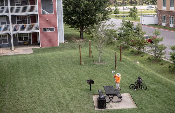 Eight-year-old Baraka plays at the apartment complex into which his family moved in Fayetteville