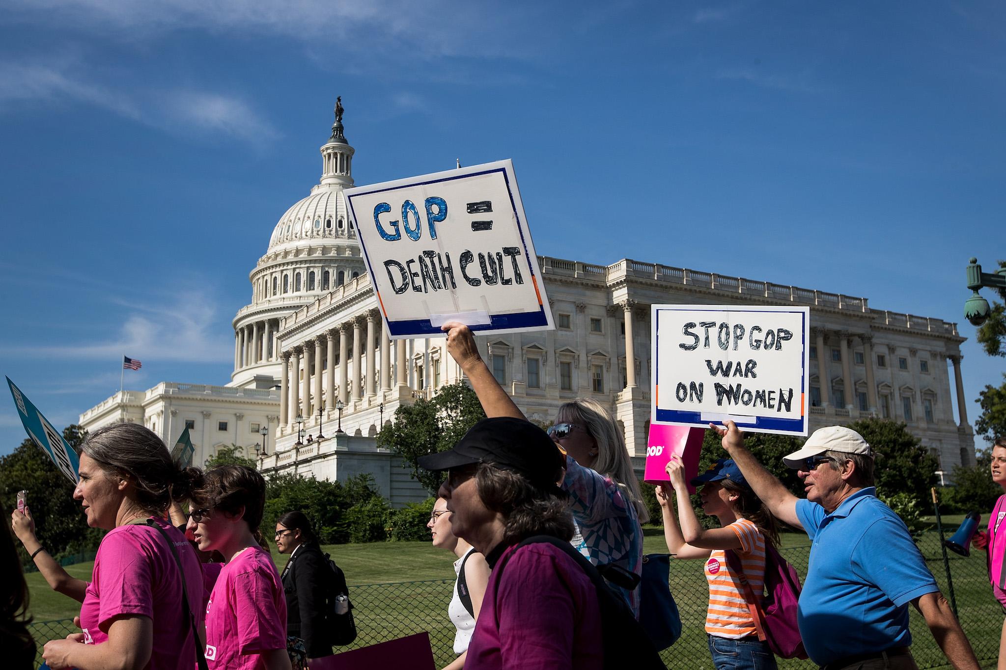 Activists march around the US Capitol to protest the Senate GOP health care bill