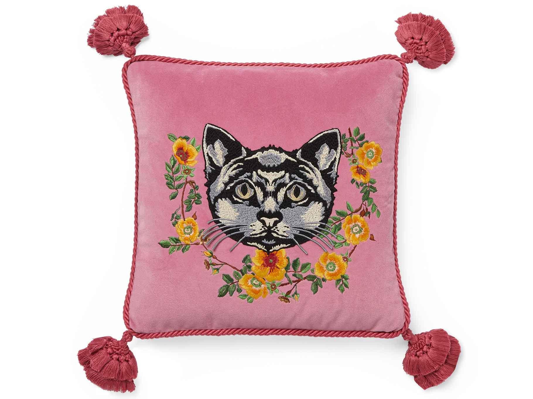 Sumptuous cushions are decorated with designs like roses, snakes and tigers (Image: Gucci)