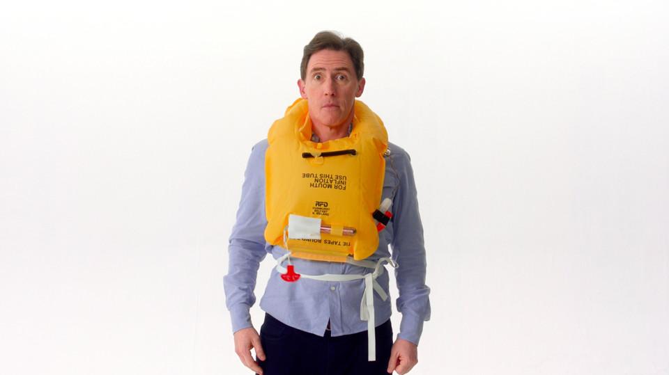 Rob Brydon demonstrates how to wear a lifejacket