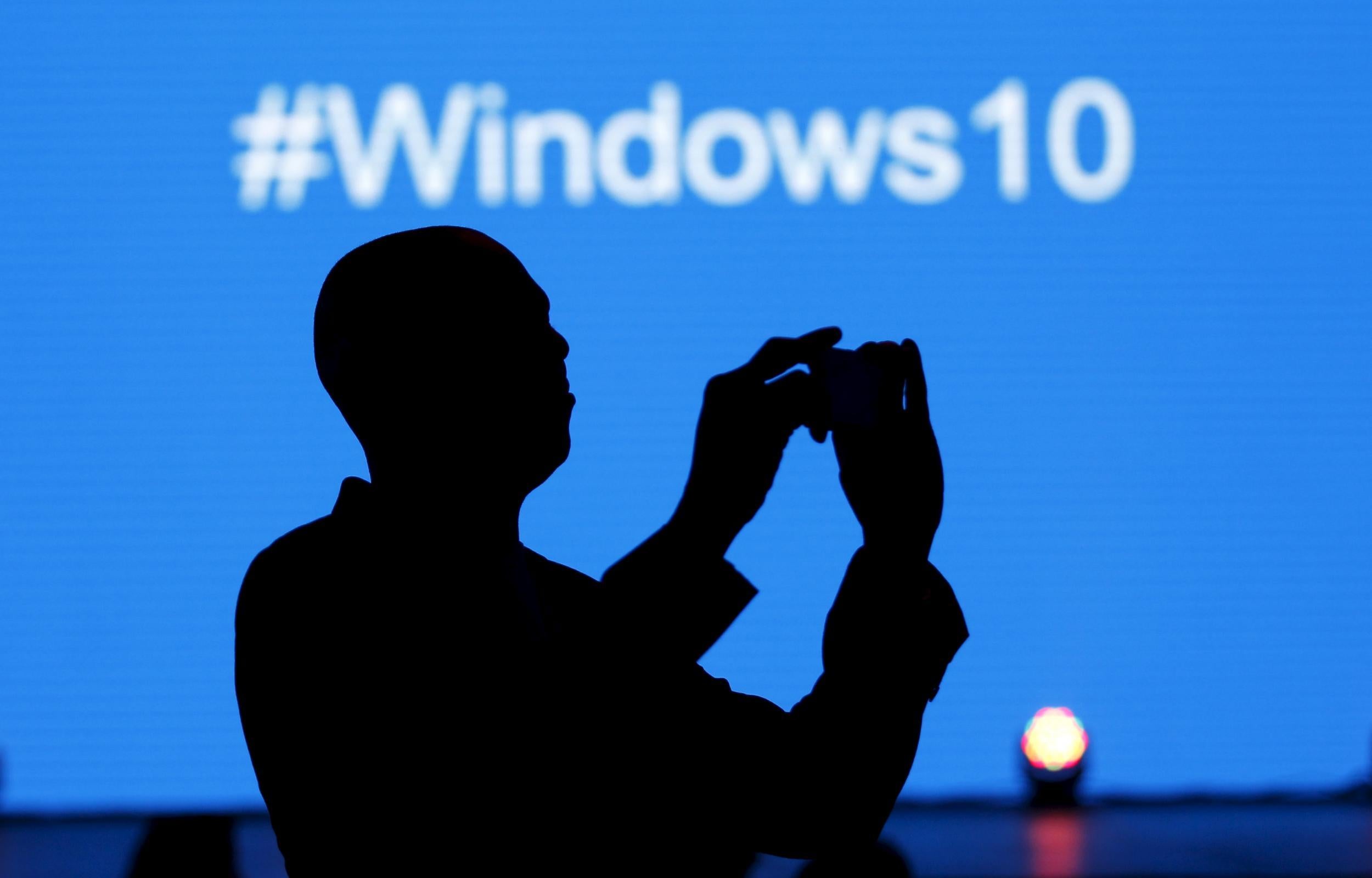 A Microsoft delegate takes a picture during the launch of the Windows 10 operating system in Kenya's capital Nairobi, July 29, 2015