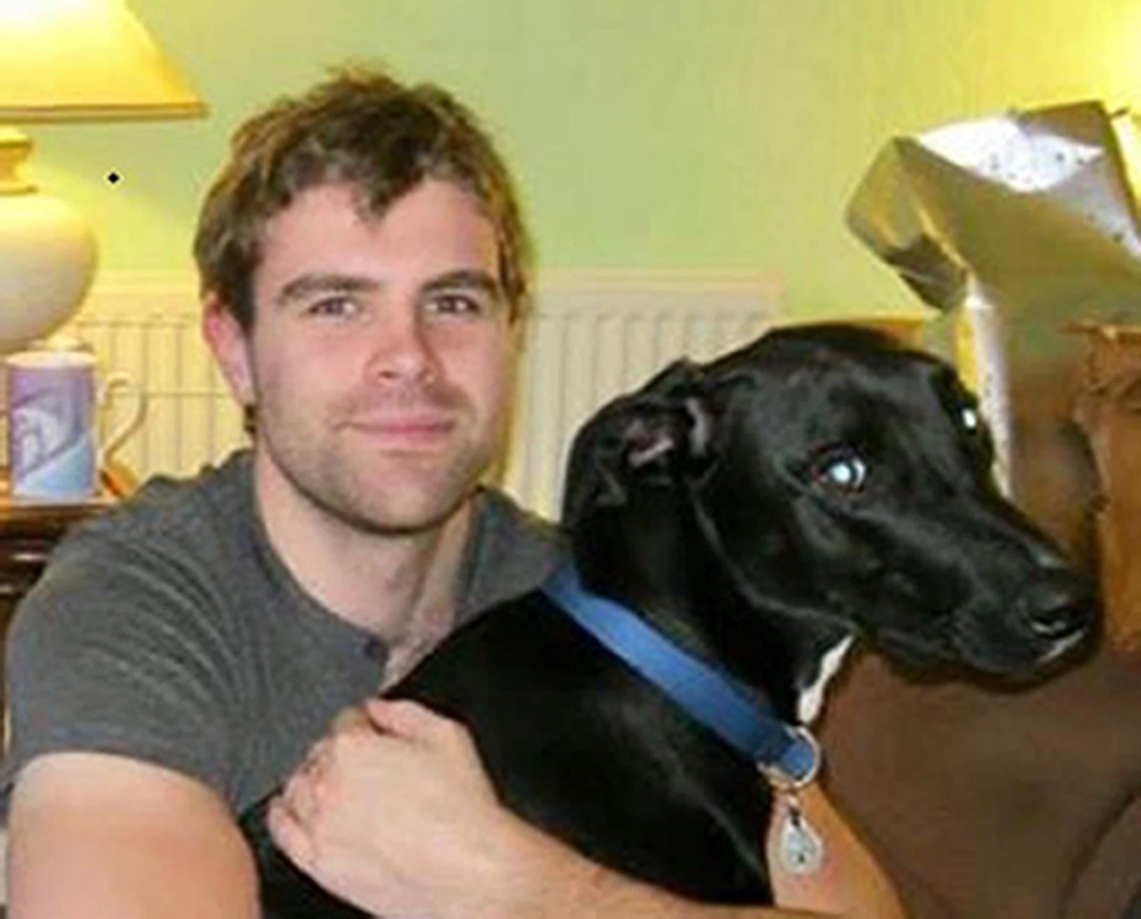 Cameron Logan, 23, with his dog Gomez, who also died in the fire