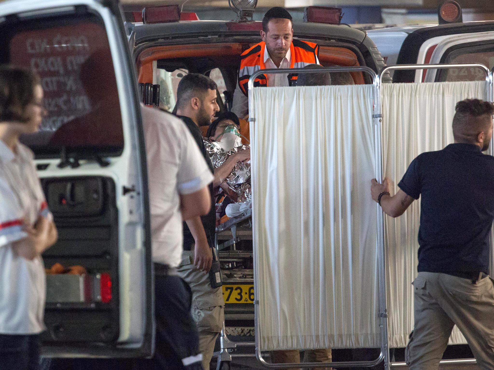 Medics evacuate an Israeli woman who was injured during a knife attack (Reuters)