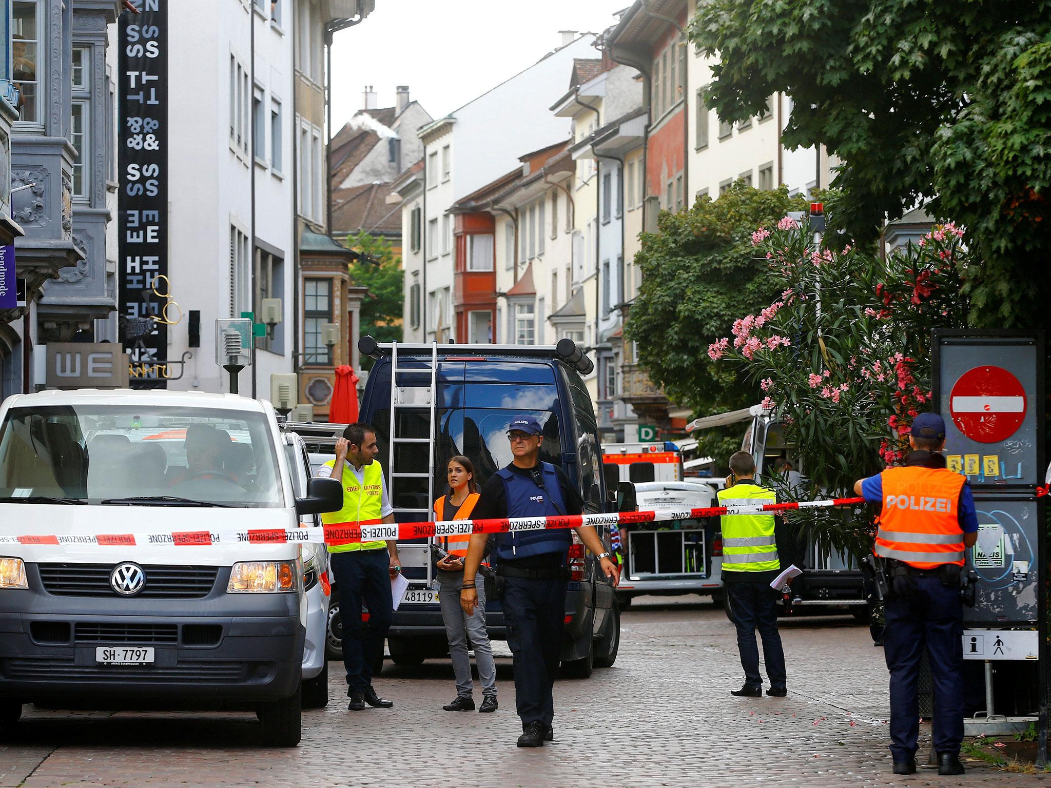 Swiss police officers stand at a crime scene in Schaffhausen, Switzerland (Reuters/Arnd Wiegmann)