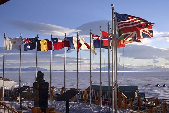 Flags of the original 12 signatory nations of the Antarctic Treaty fly next to a bust of Admiral Richard Byrd (Getty)