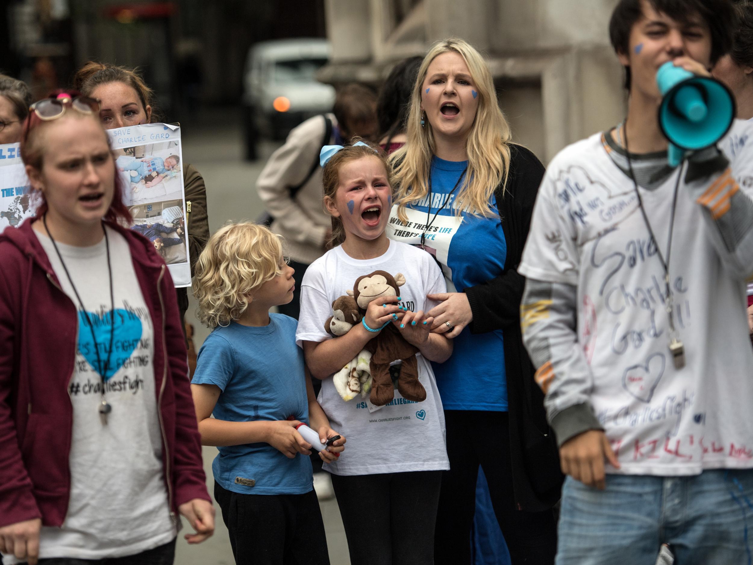 Campaigners outside the High Court where the terminally ill baby’s gave an emotional statement after ending their legal fight for an experimental treatment