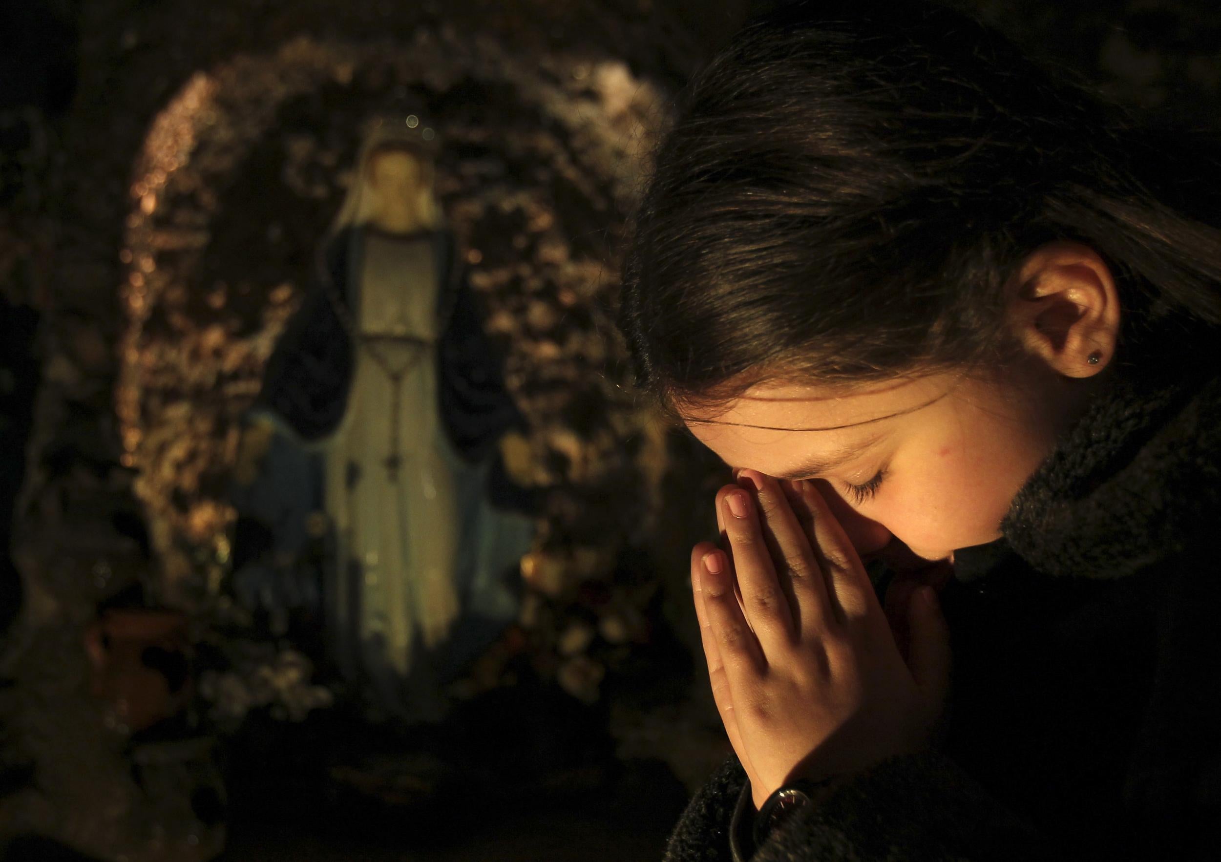 An Iraqi girl attends a Christmas mass at Chaldean Catholic church in Amman