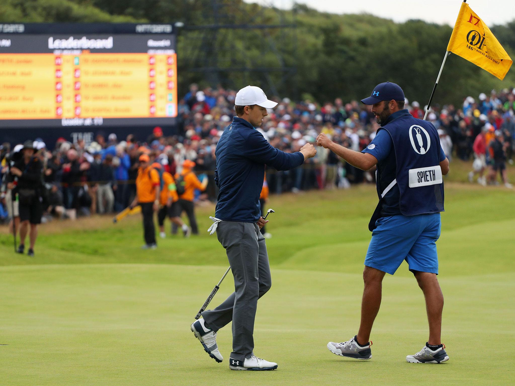 Jordan Spieth and Michael Greller share a quick fist-bump on the 17th hole of Royal Birkdale