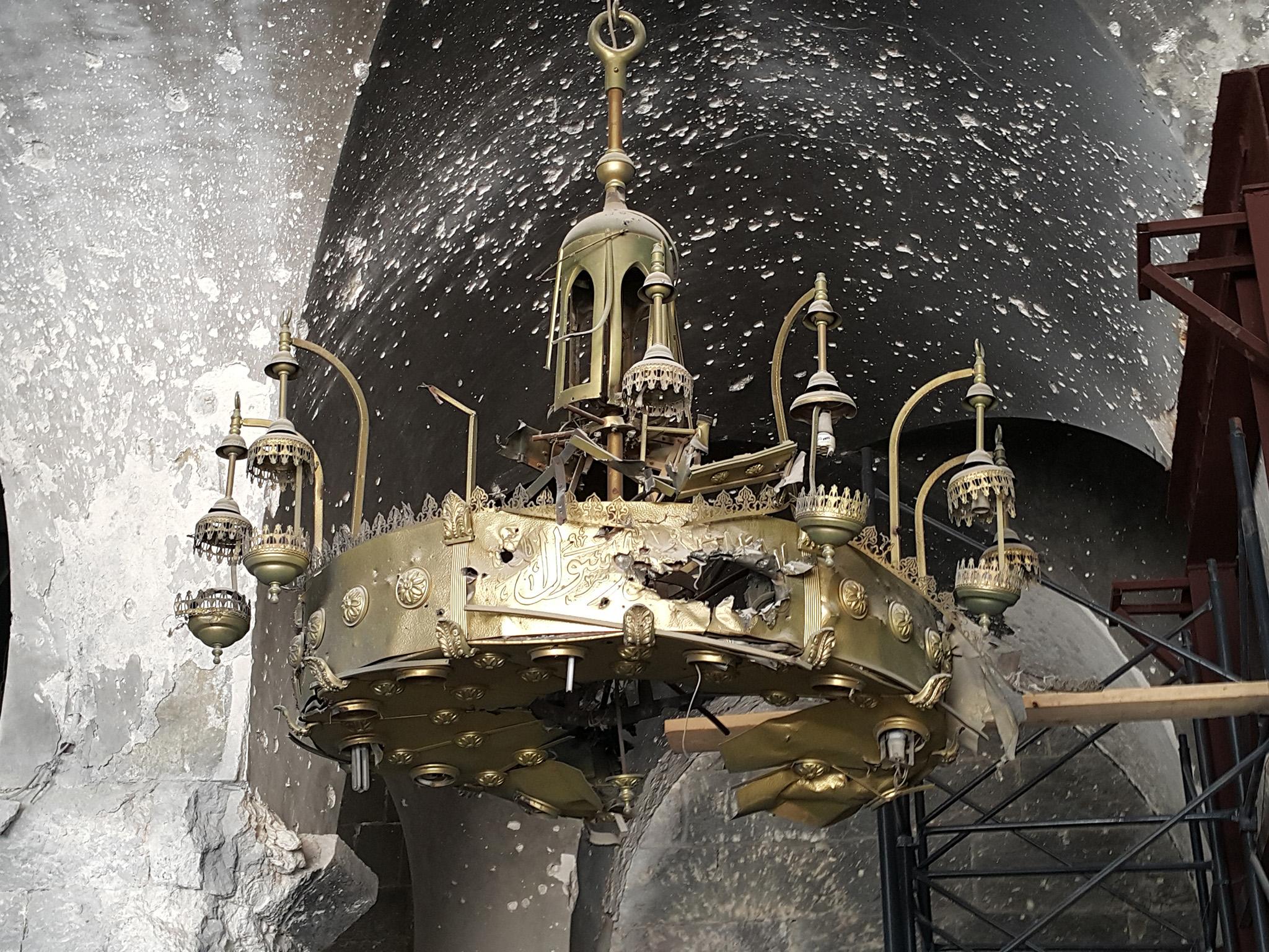 &#13;
Brass chandeliers in the Aleppo Great Mosque were shattered by bullets. (Photo: Nelofer Pazira)&#13;