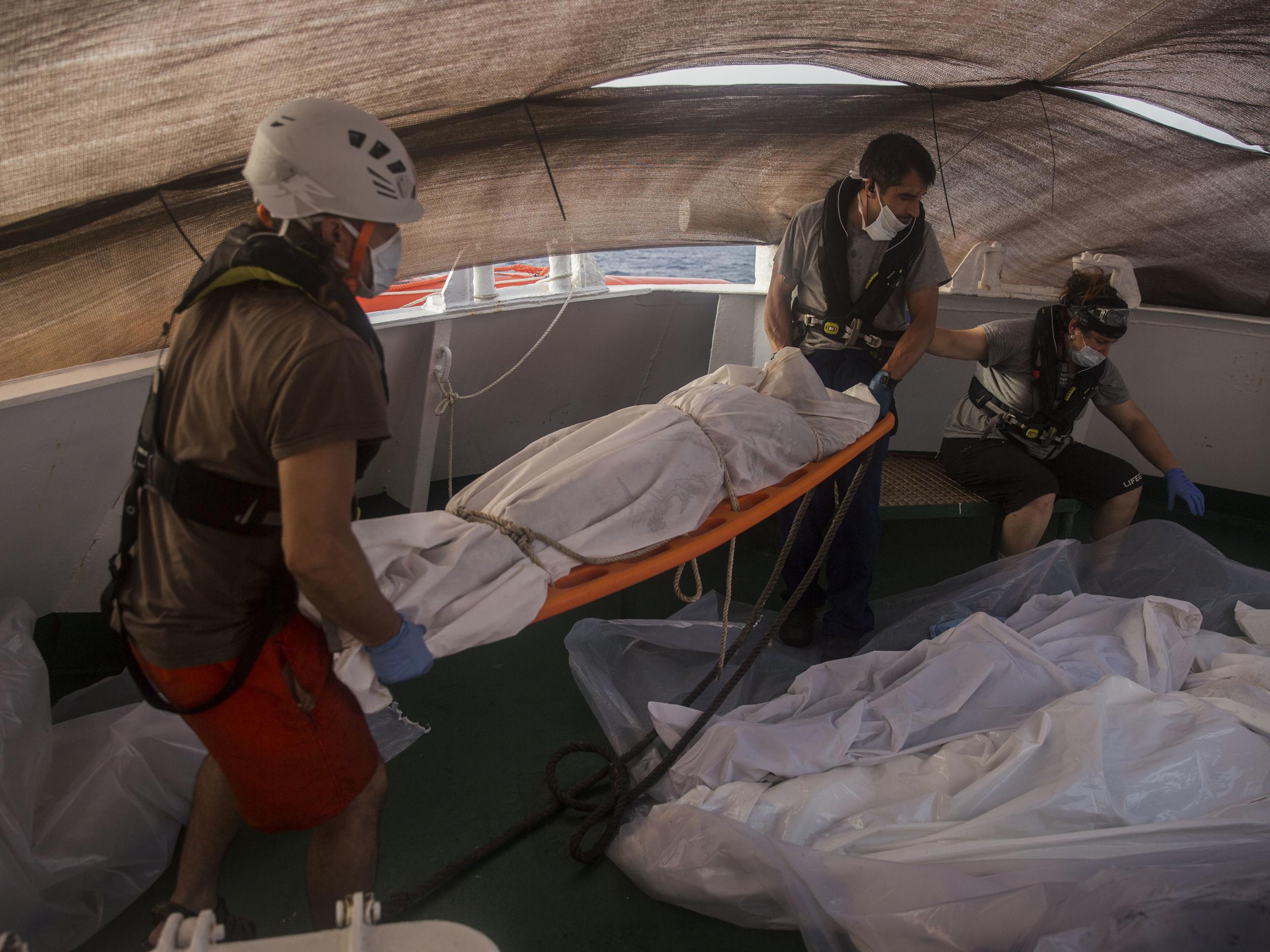 Aid workers of Proactiva Open Arms recover dead bodies