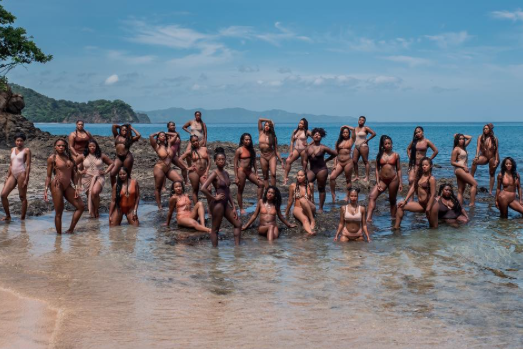 The group of 56 sisters donned bathing suits that matched their skin tones and posed in the sea and sand