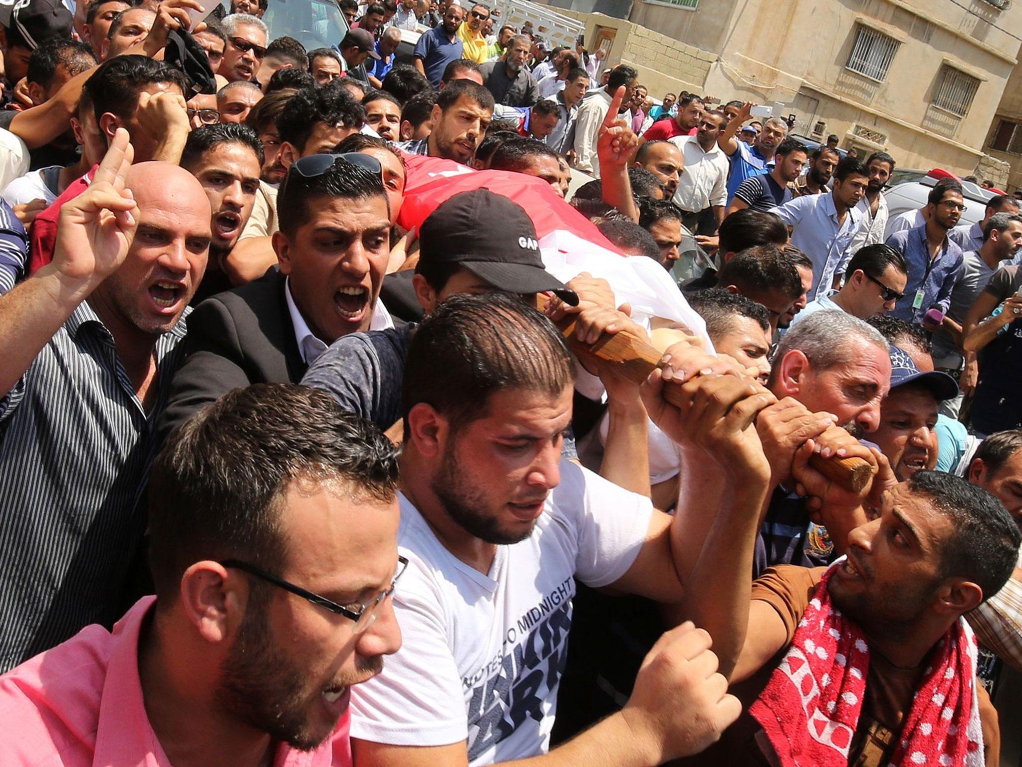 Mourners carry the body of 17-year-old Mohammed Jawawdeh