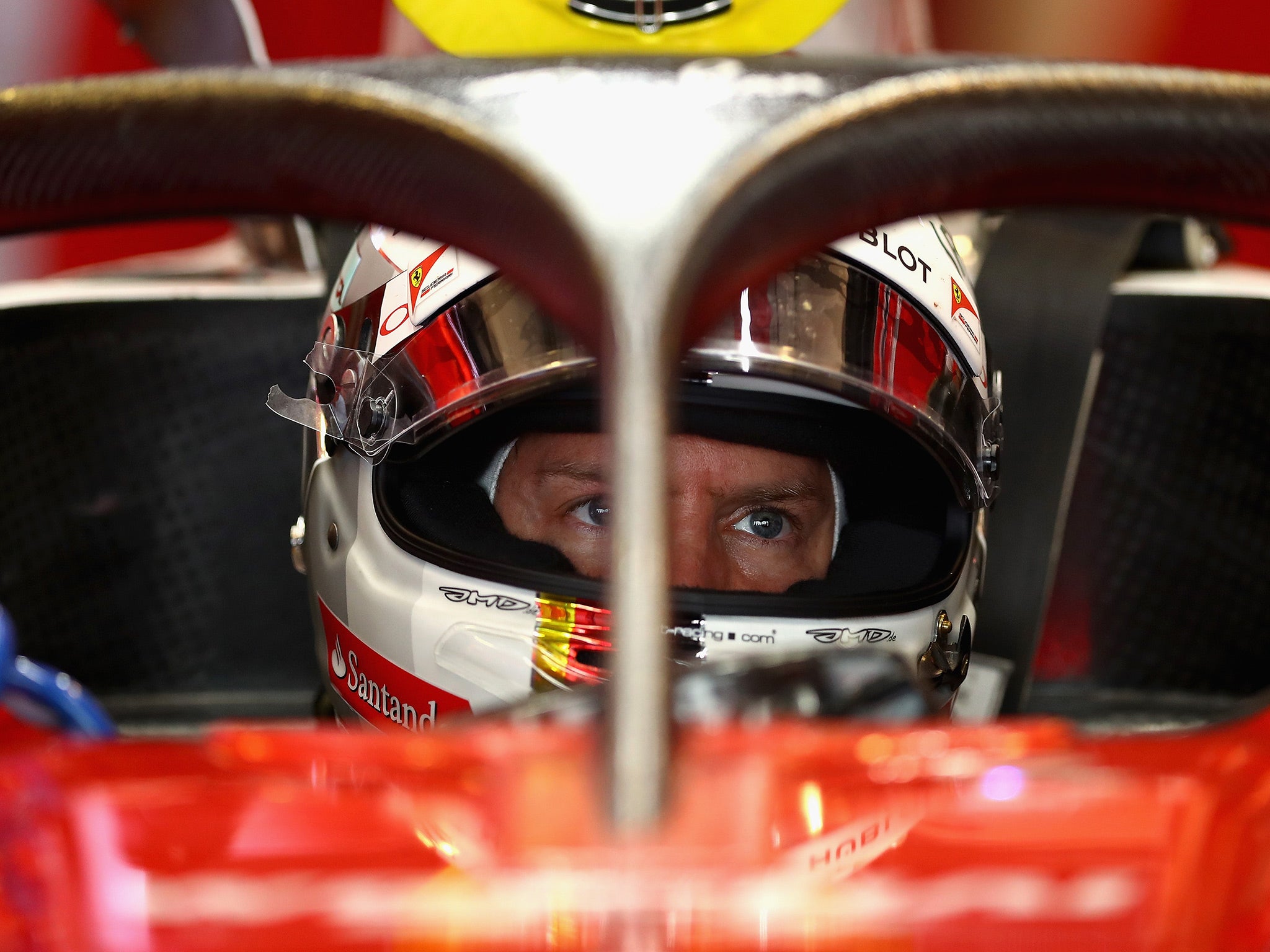 Sebastian Vettel, pictured sitting behind the 'halo' on his Ferrari