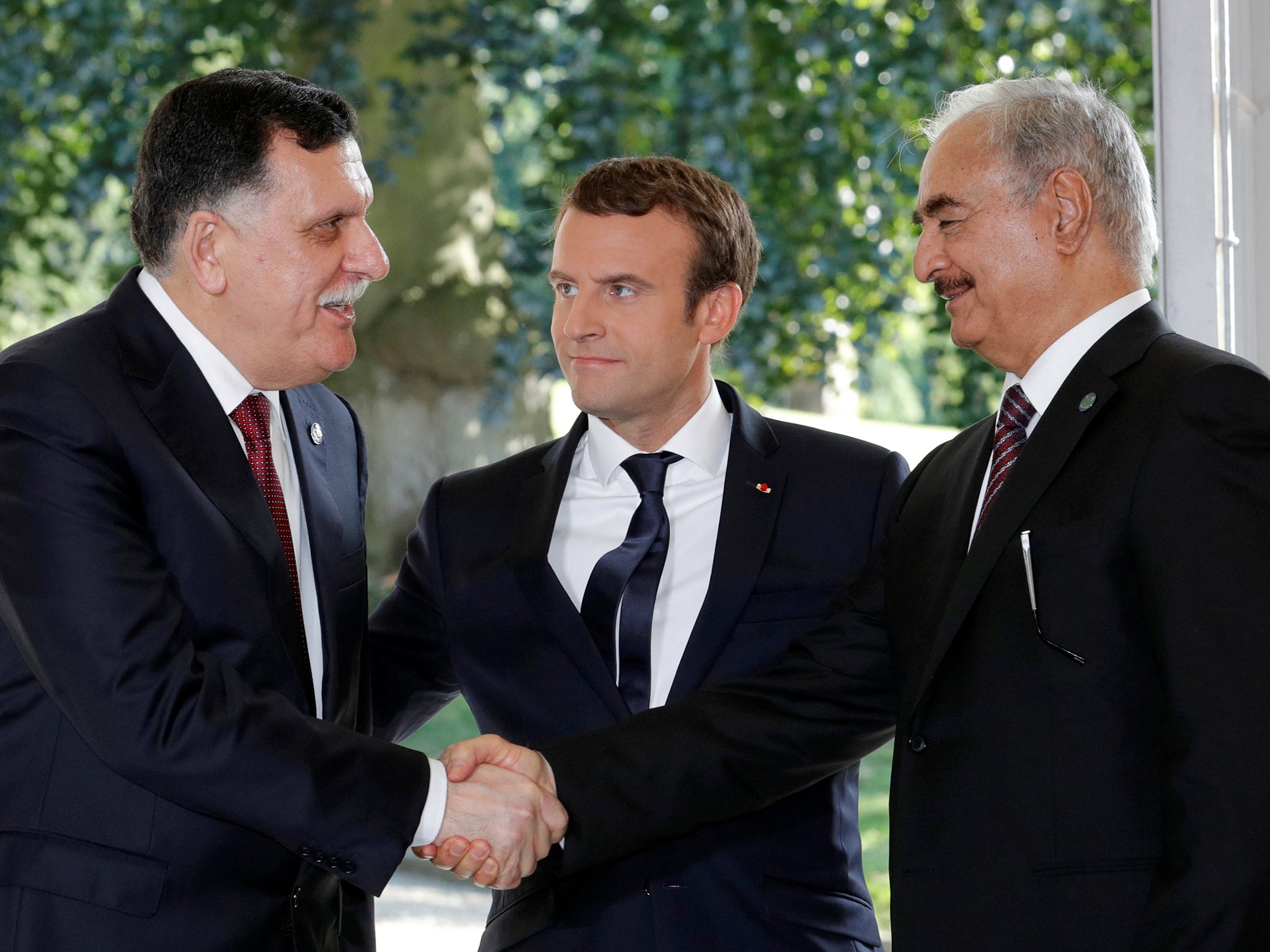 French President with Libyan Prime Minister Fayez al-Sarraj (L), and General Khalifa Haftar (R), commander in the Libyan National Army (Reuters )