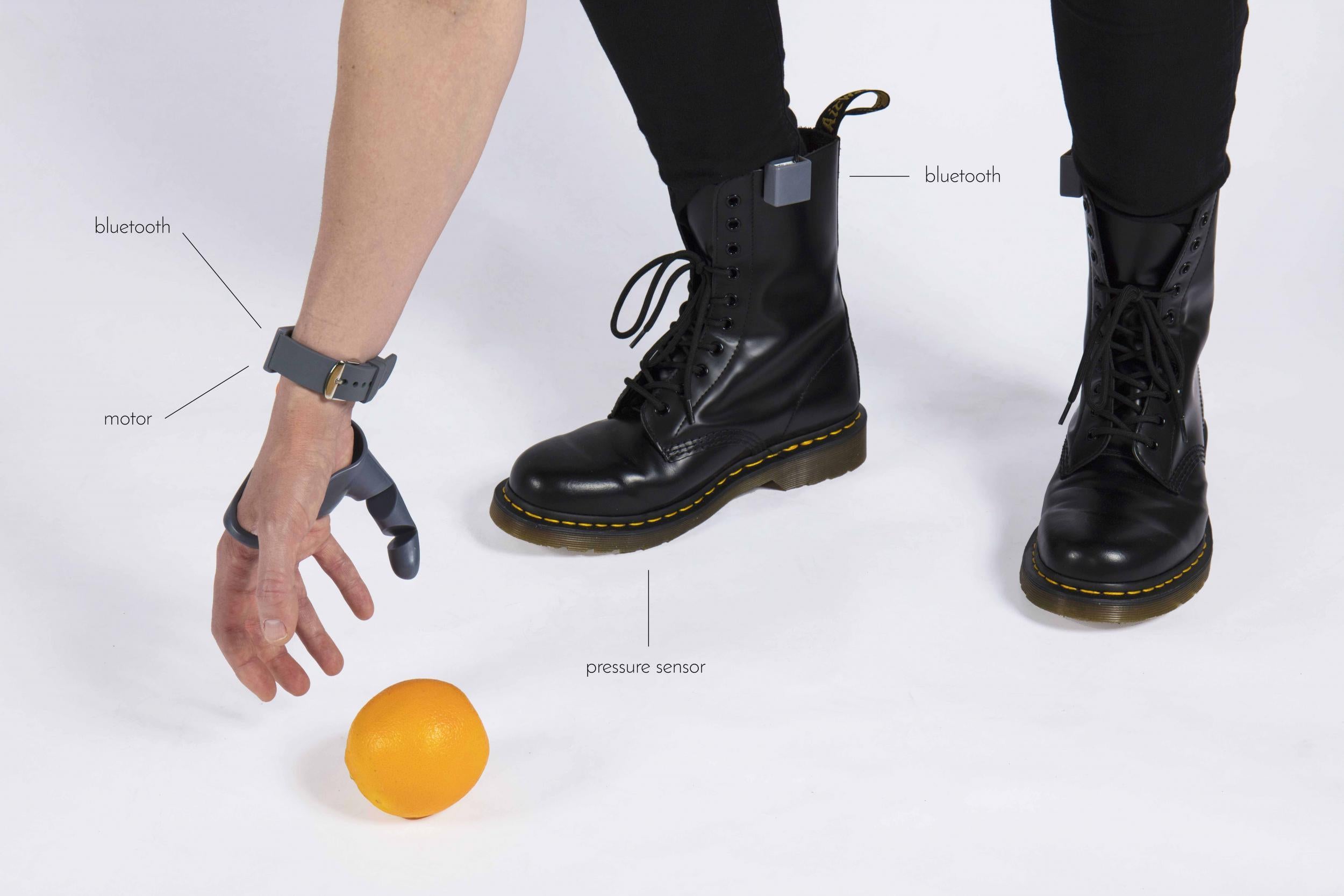 A bracelet receives signals from a bluetooth device that detects movements in the wearer’s foot. To operate, the wearer just has to press down with one of their feet