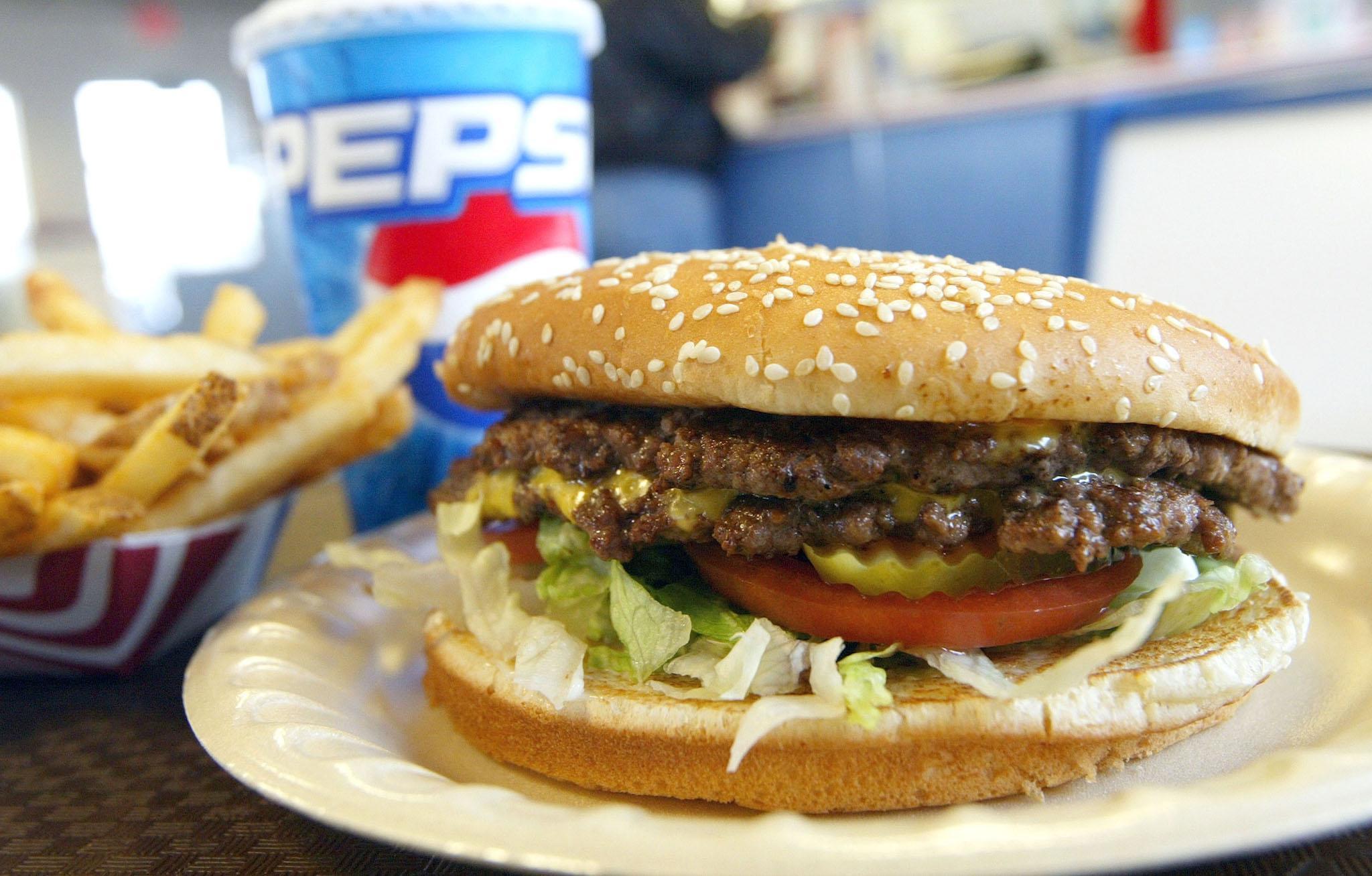 A double cheeseburger, fries and soda lie on a table at Majors Hamburgers December 28, 2003 in Yakima, Washington