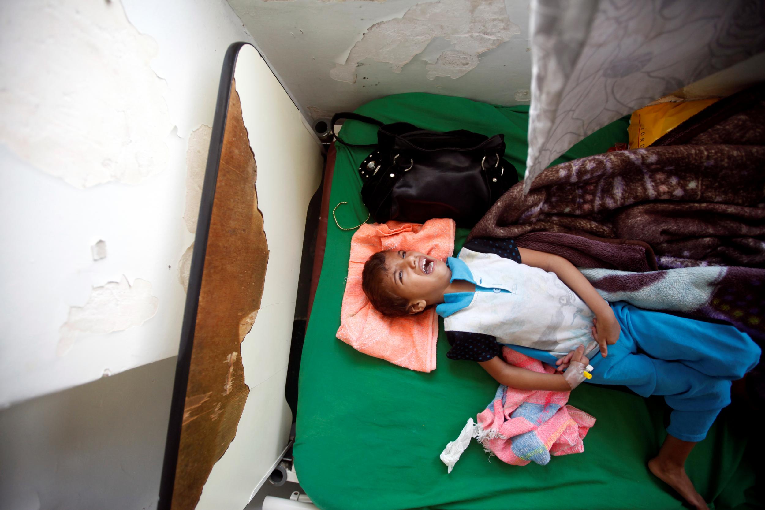 A boy cries as he lies on a bed of a hospital in Sanaa, Yemen on 27 July, 2017. Less than half of the country's medical facilities are functional in the face of a huge cholera epidemic